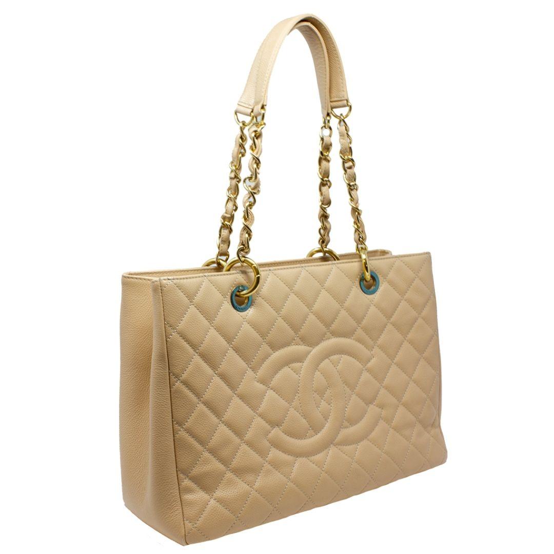 Gorgeous, elegant, classic Chanel tan/beige quilted Caviar leather Chanel Grand Shopping Tote from the 2013 collection. This beauty is rendered with a very well paired gold-tone hardware, tonal dual woven leather and chain-link shoulder straps. We