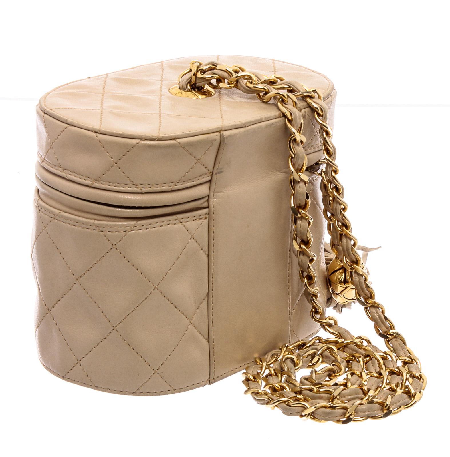 Vintage Chanel mini vanity case featuring quilted beige lambskin leather, gold-tone chain link strap, leather fringe tassel zipper and classic 'CC' logo imprinted at bottom of bag.

21486MSC MLR