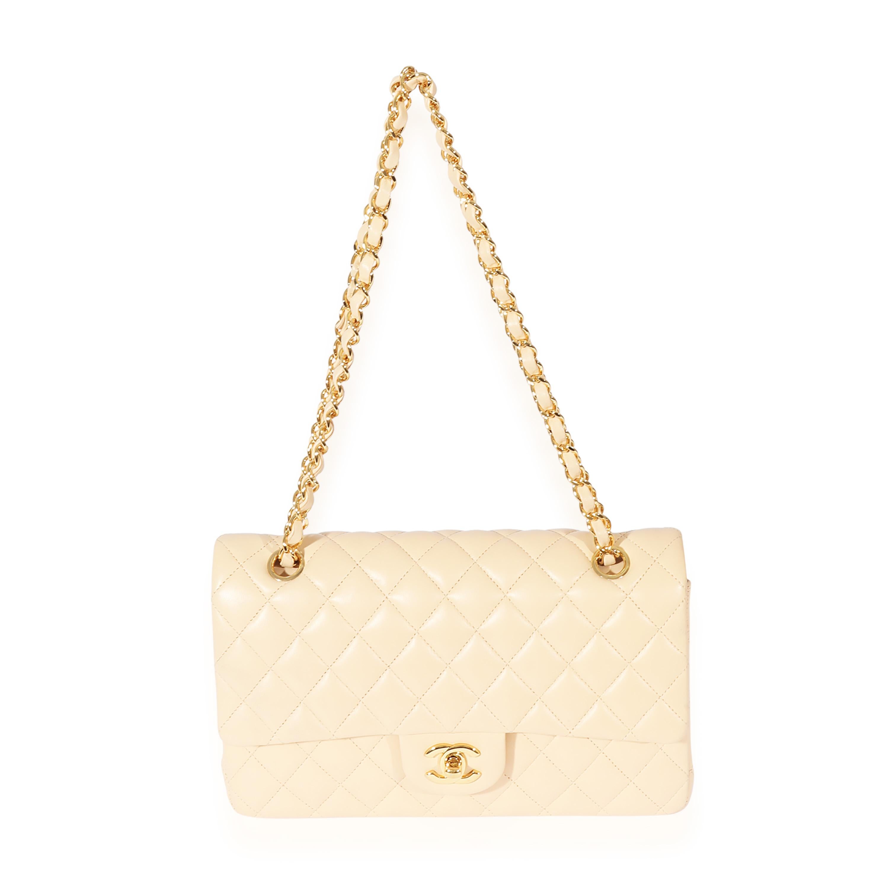 Listing Title: Chanel Beige Lambskin Medium Classic Flap Bag
SKU: 127764
MSRP: 8800.00
Condition: Pre-owned 
Handbag Condition: Very Good
Condition Comments: Very Good Condition. Exterior scuffing at corners and throughout. Light scratching at