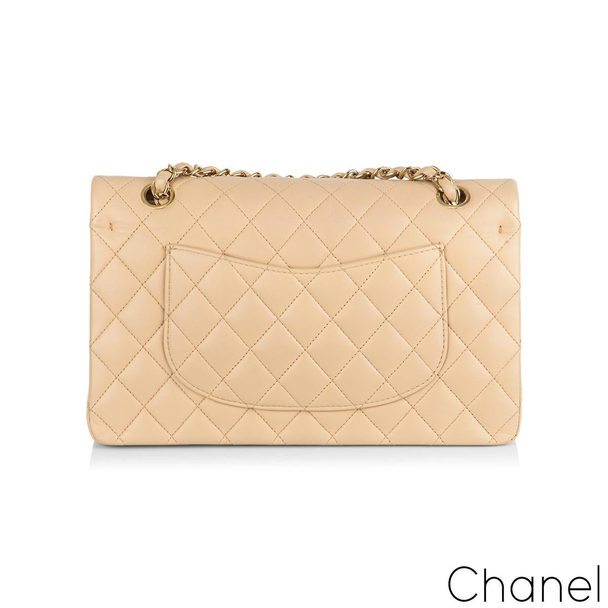 A Timeless Chanel Classic Double Flap Handbag. The exterior of this medium classic is in beige lambskin leather with gold tone hardware. It features a front flap with signature CC turnlock closure, half moon back pocket, and adjustable interwoven