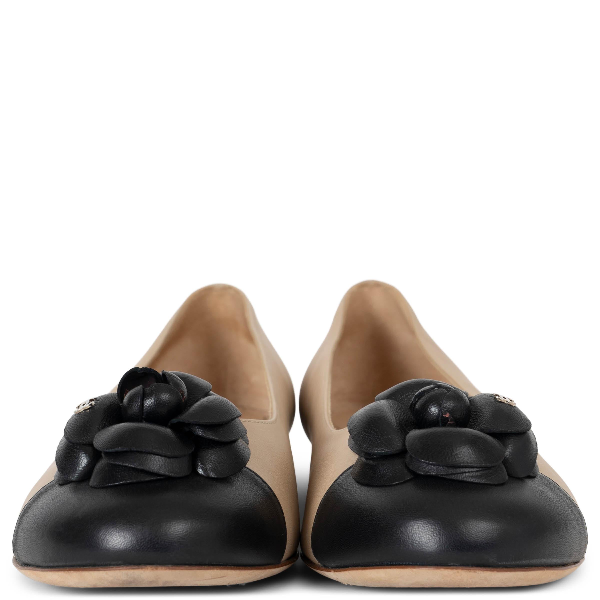 These 100% authentic Chanel classic ballet flats are crafted in elegant beige calfskin with a timeless black cap toe. The toe is adorned with a signature camellia embellishment, adding a delicate and iconic Chanel touch. The interior is lined in