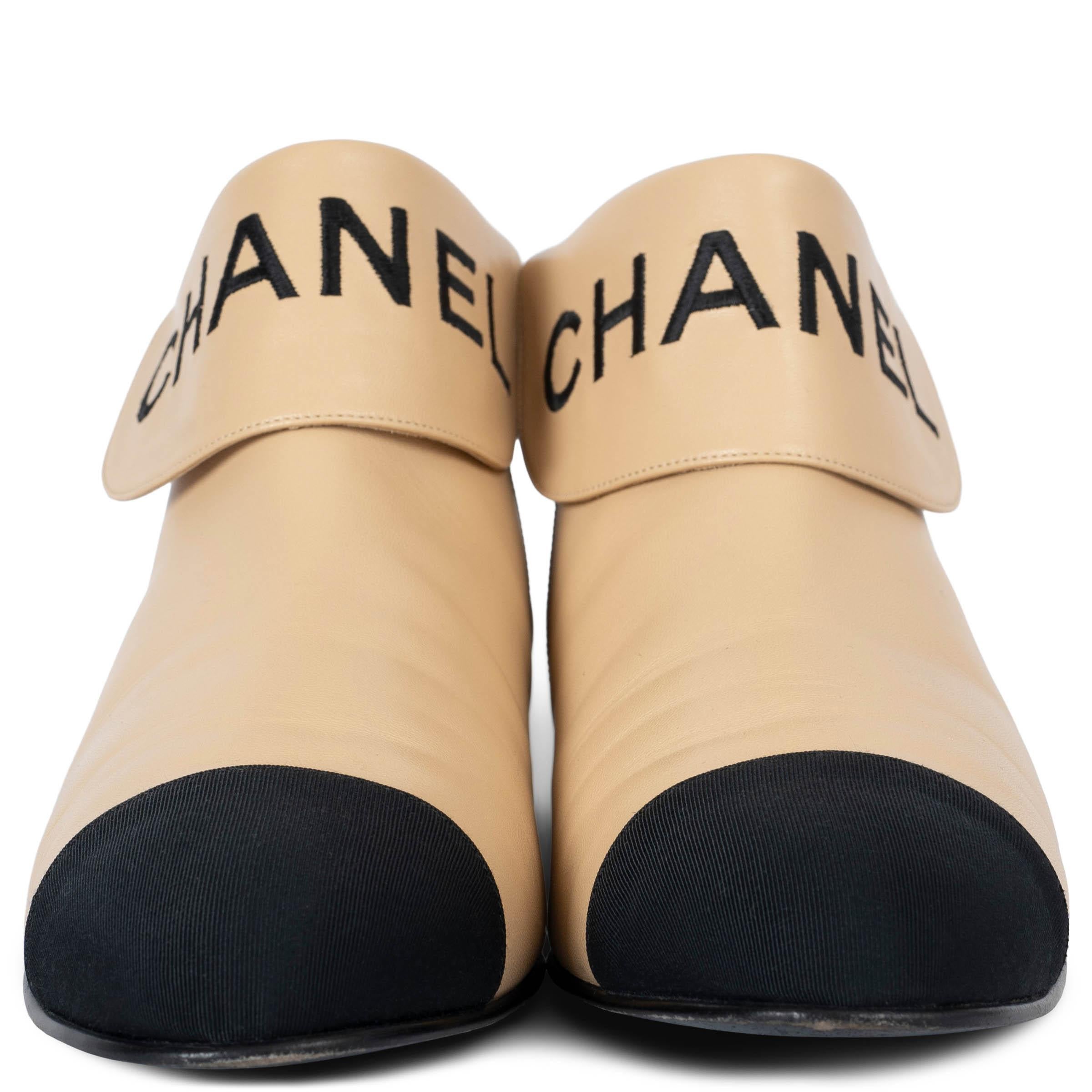 100% authentic Chanel fold-over flat ankle boots in beige lambskin leather. Feature black embroidered logo lettering around the ankle and grosgrain toe cap. Have been worn and are in excellent condition. 

2019 Pre-Fall

Measurements
Model	19B