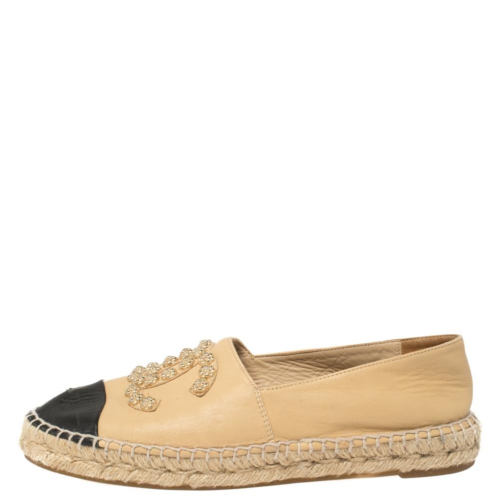 Wear these Chanel leather espadrilles all summer long! Crafted from beige leather, they are adorned with gold-tone Camellia-shaped studs, forming signature CC signs on their vamps. They have black toe caps, rubber soles and Chanel labeled insoles.

