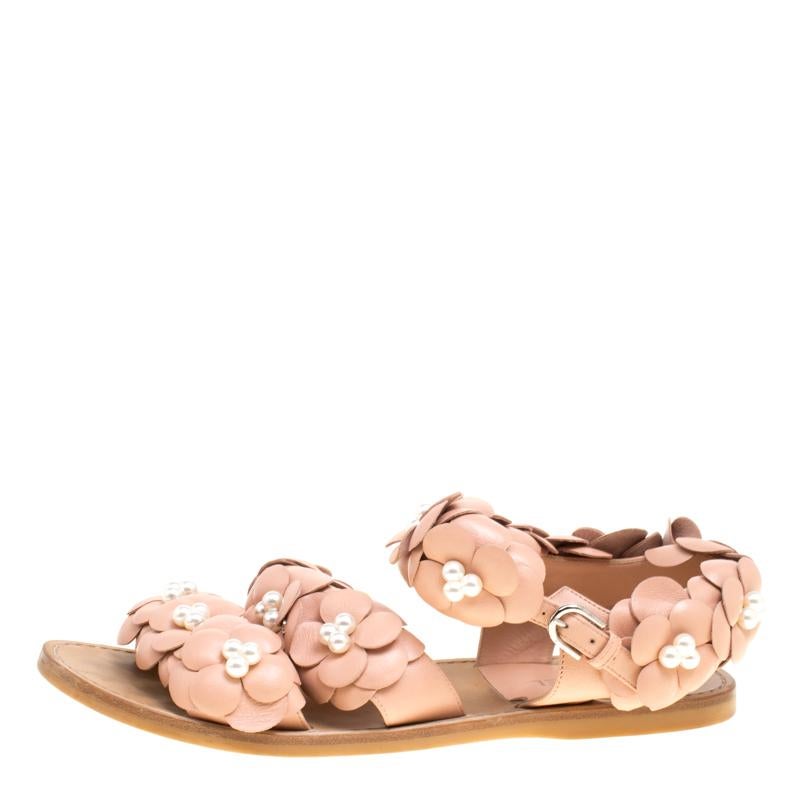 Flaunt your happy mood with these decorative Chanel Camellia sandals. These distinctive sandals are accented with floral decorations and faux pearls on all over the top area making it a perfect match for short evening dresses. There is a thick