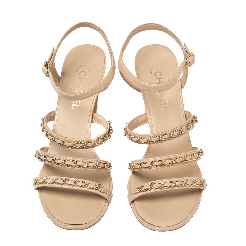 These sandals from the House of Chanel are truly a beautiful creation! They are made from beige leather, with gold-toned chain-link embellishments highlighting their upper. They come with open-toes, block heels, and an ankle strap. Add them to your
