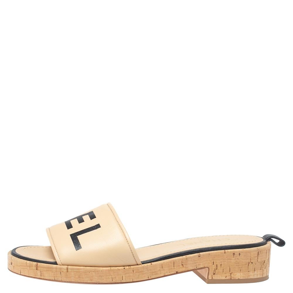 For days of ease and style, Chanel created these pretty slides. They have uppers crafted from quality leather and detailed with 'CHANEL', low heels and insoles lined with leather for comfort. The beige-hued cork slides will come in handy with many