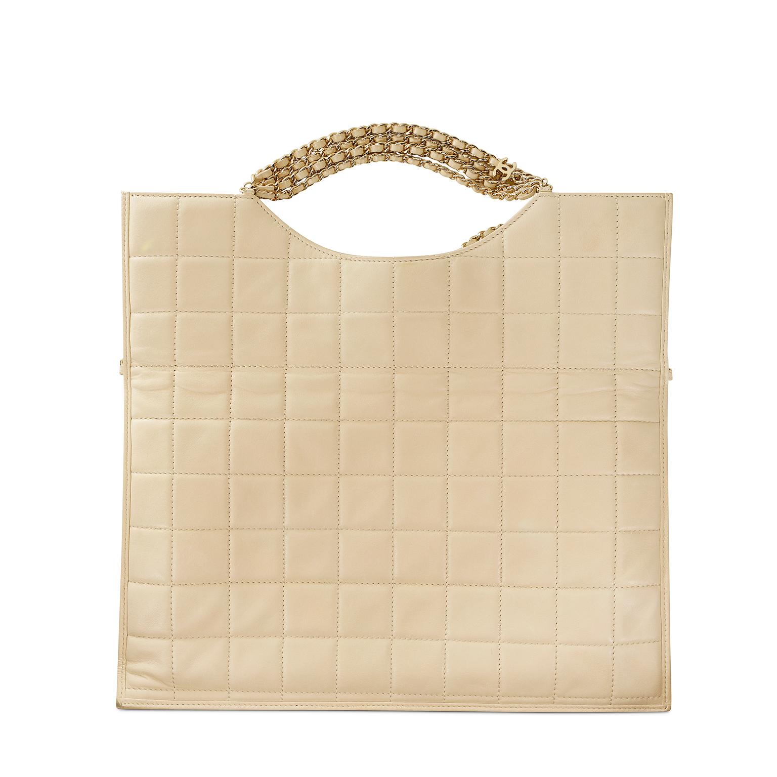 Chanel Beige Leather Four Chain Clutch- Excellent Plus Condition
An optional shoulder strap adds a convertible dimension making it both stylish and practical.  
Beige leather slim clutch is quilted in square pattern.  Fold down top has multiple gold