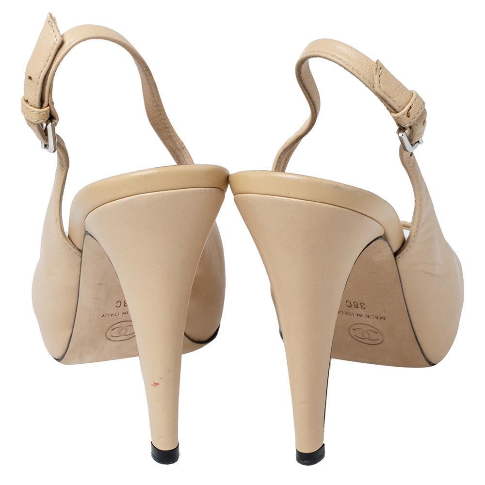 Offering comfort with elegance, these Chanel slingback sandals are a wardrobe essential. Crafted in beige leather, the open-toe sandals feature platforms, CC logo detailing, and 12 cm heels.

