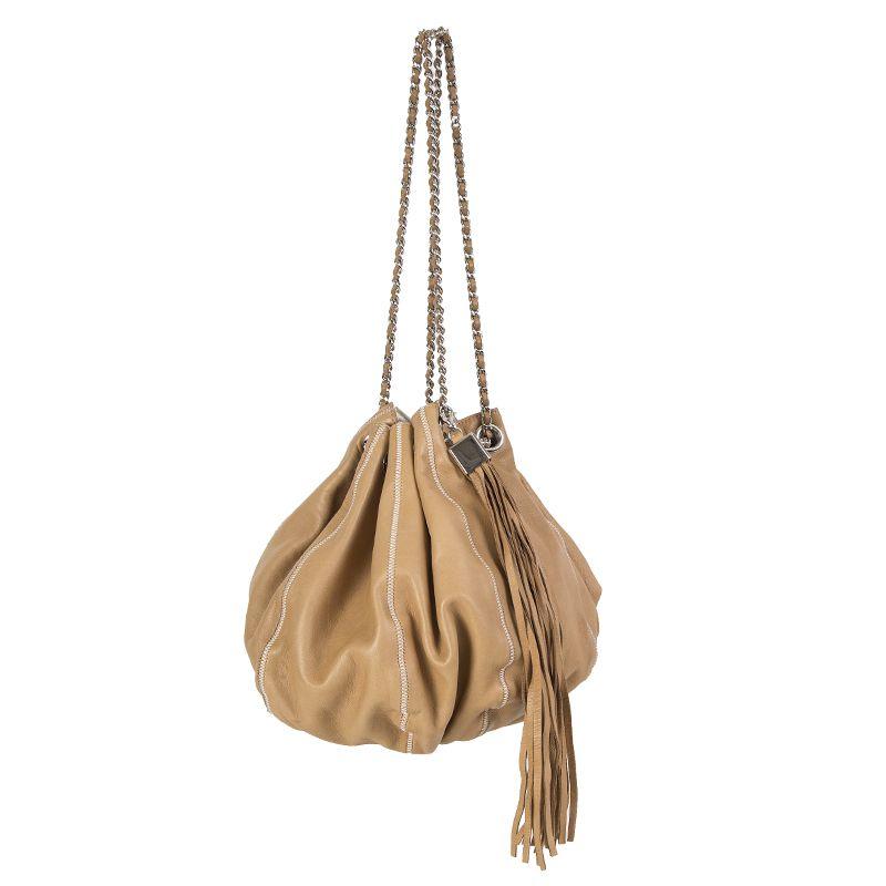 Chanel 'Reversible Tassel Small Bucket' bag in tan leather and off-white satin. Removable tassel detail. Has been carried with signs of use on the leather and satin. Overall in very good condition. Comes with dust bag.

Height 29cm (11.3in)
Width