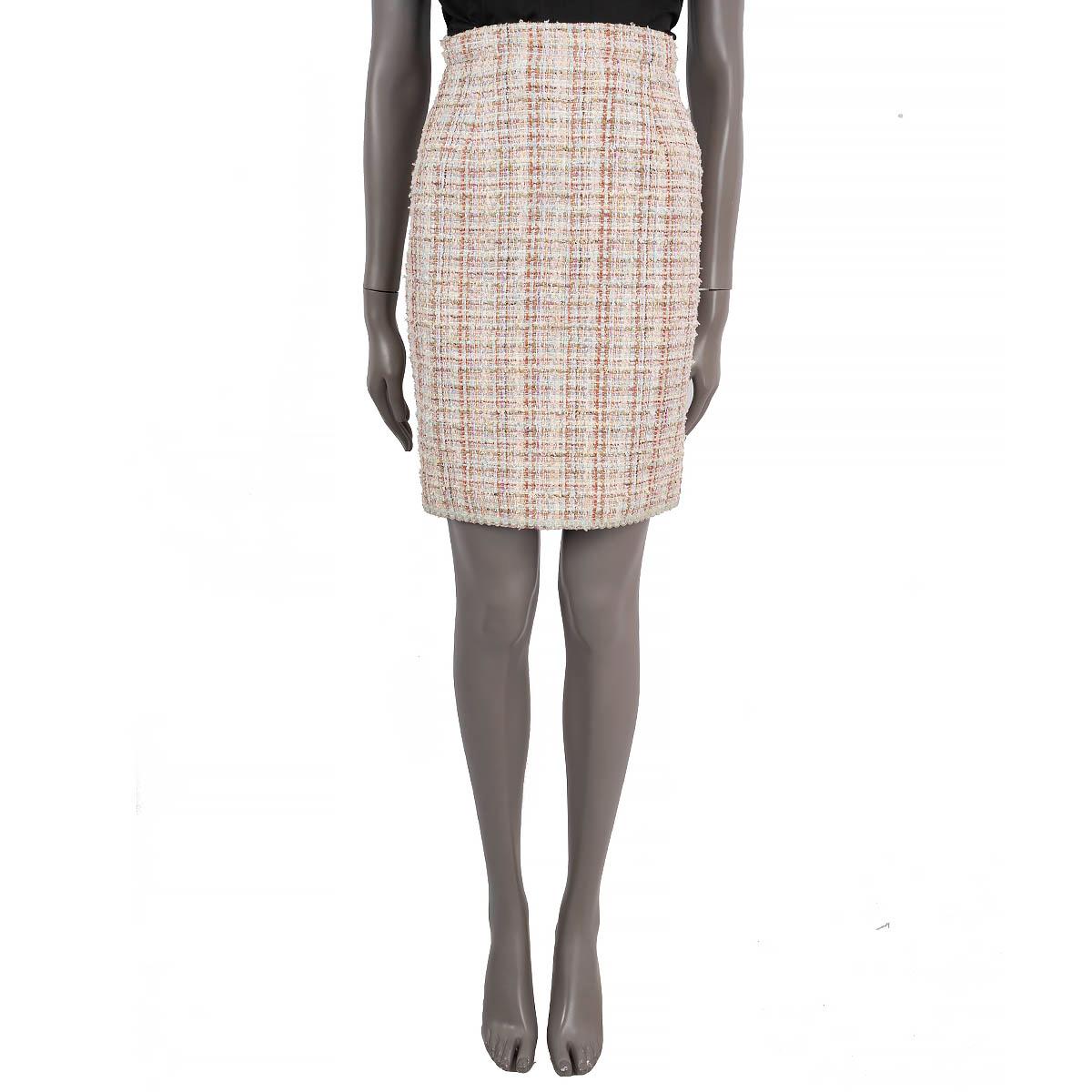 100% authentic Chanel classic tweed skirt in pastel blue, pink, beige and olive green cotton (55%), polyamide (27%), viscose (15%), metallized polyester (2%) and acrylic (1%). Features a button kick pleat with three pink enamelled camellia buttons.