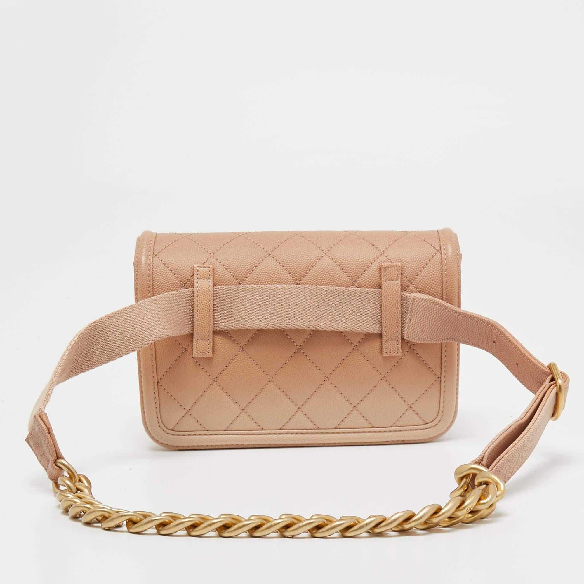 This belt bag from Chanel is indeed functional yet fashionable. It is crafted from quilted leather and displays the CC logo on the front in gold tone. It is completed with a front flap that reveals a well-sized interior. Wear it over jumpsuits for