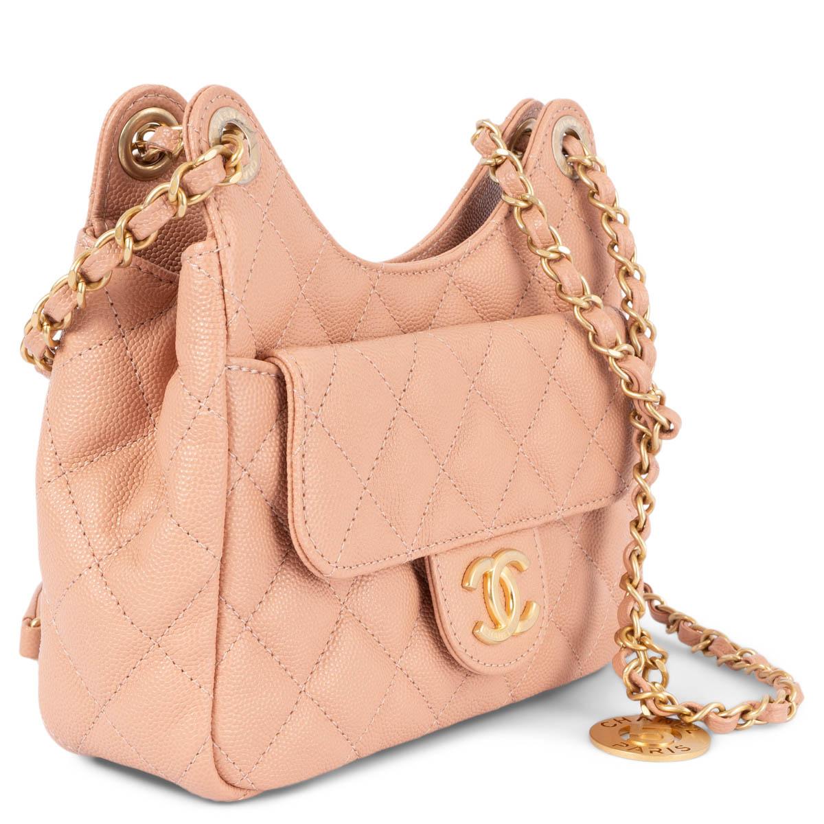 100% authentic Chanel Wavy Hobo Small shoulder bag in beige-peach Caviar leather. Features a front flap pocket with magnetic snap, an open back pocket, light gold-tone hardware. Lined in beige grosgrain fabric with an open pocket against the back.