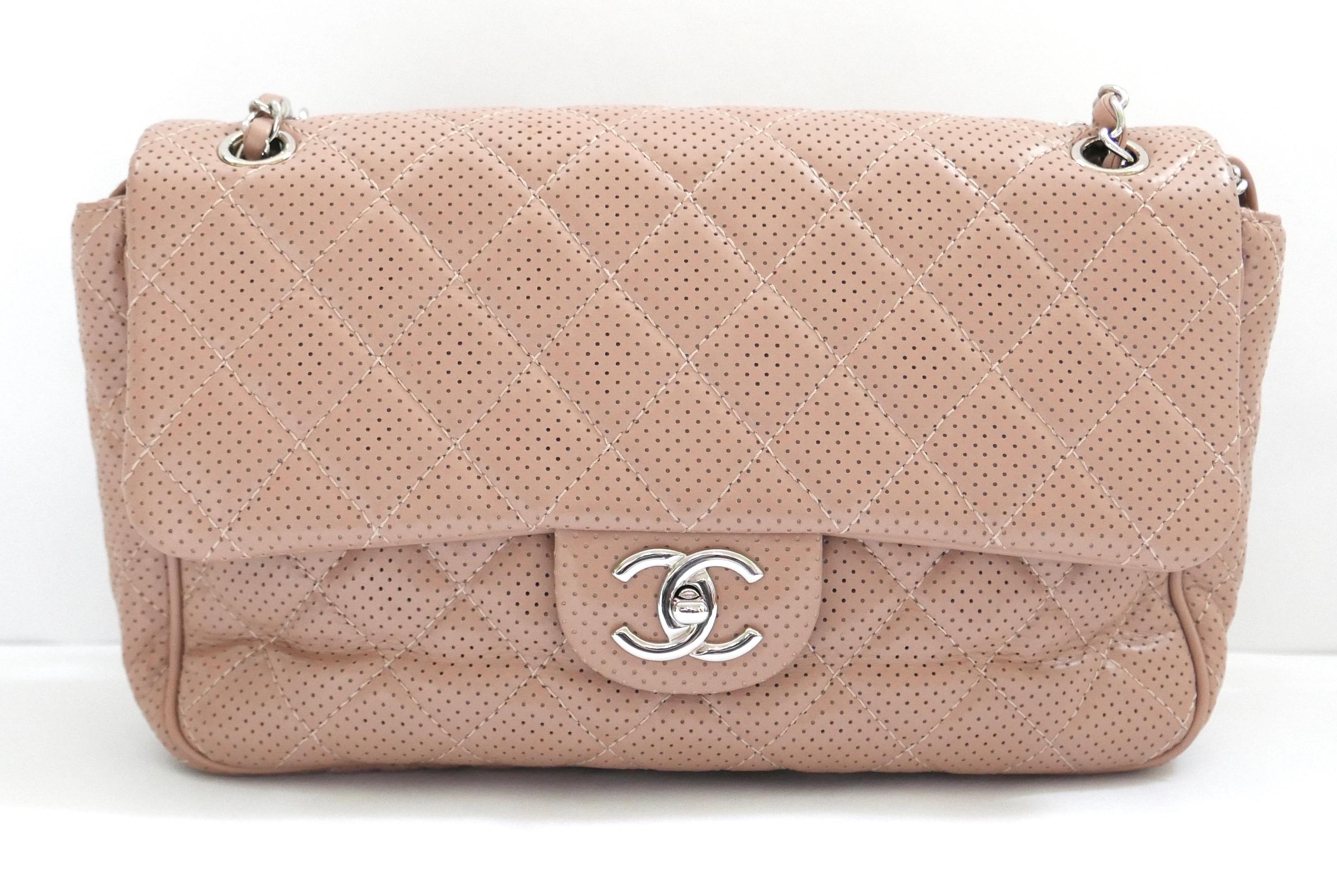Gorgeous Chanel Classique Flap Bag - unused with original Chanel tissue inside, authenticity card and Chanel dustbag. Made from smooth beige perforated leather with iconic quilted pattern, chain handle with shoulder pad and twist clasp. Lined in
