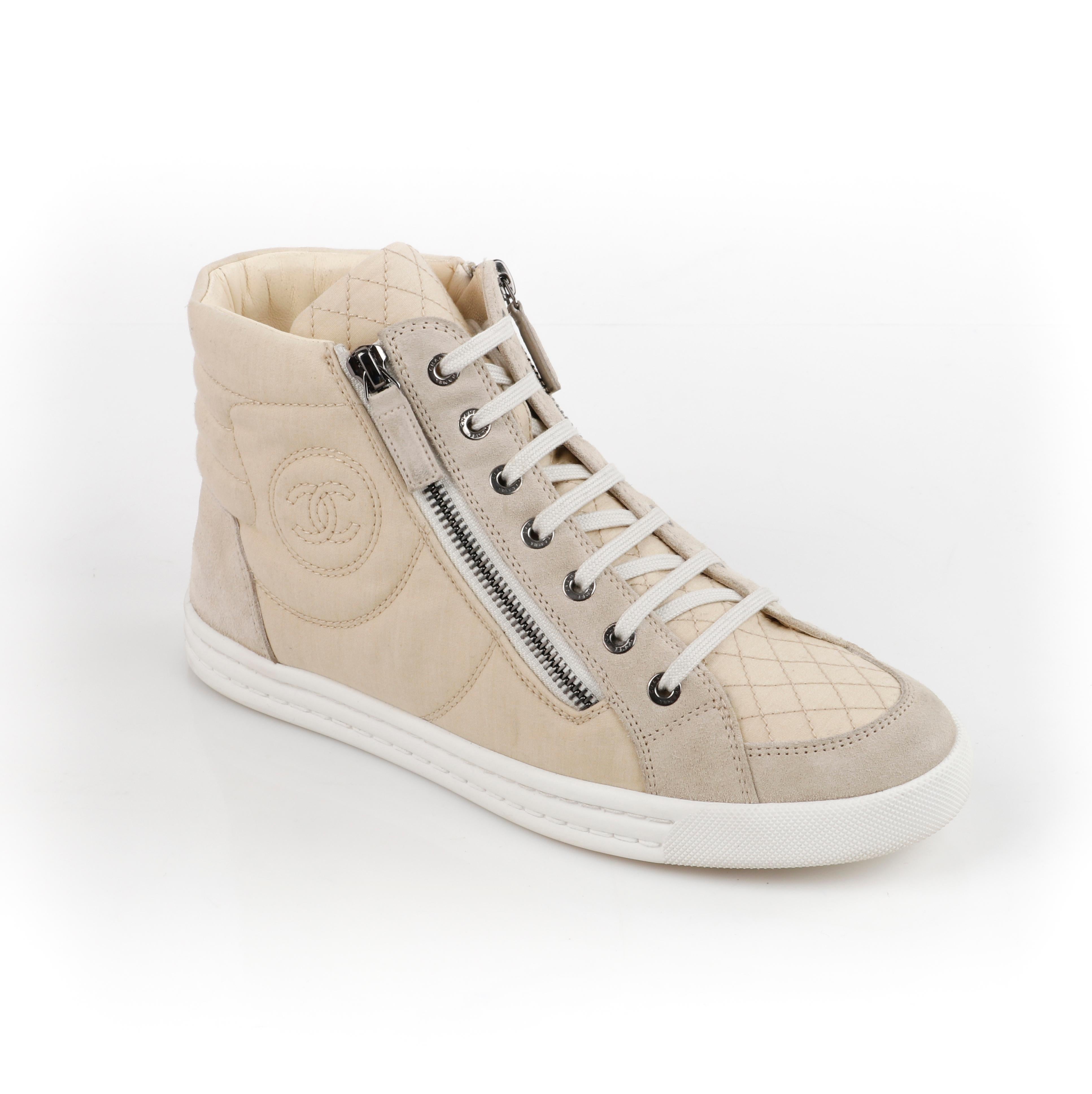 CHANEL Beige Quilted Canvas Lace Up High Top Sneakers
 
Brand / Manufacturer: Chanel
Style: High Top Sneakers
Color(s): Beige
Unmarked Materials (feel of): Canvas & Suede (upper); Rubber (soles); Leather (insoles).  
Additional Details / Inclusions: