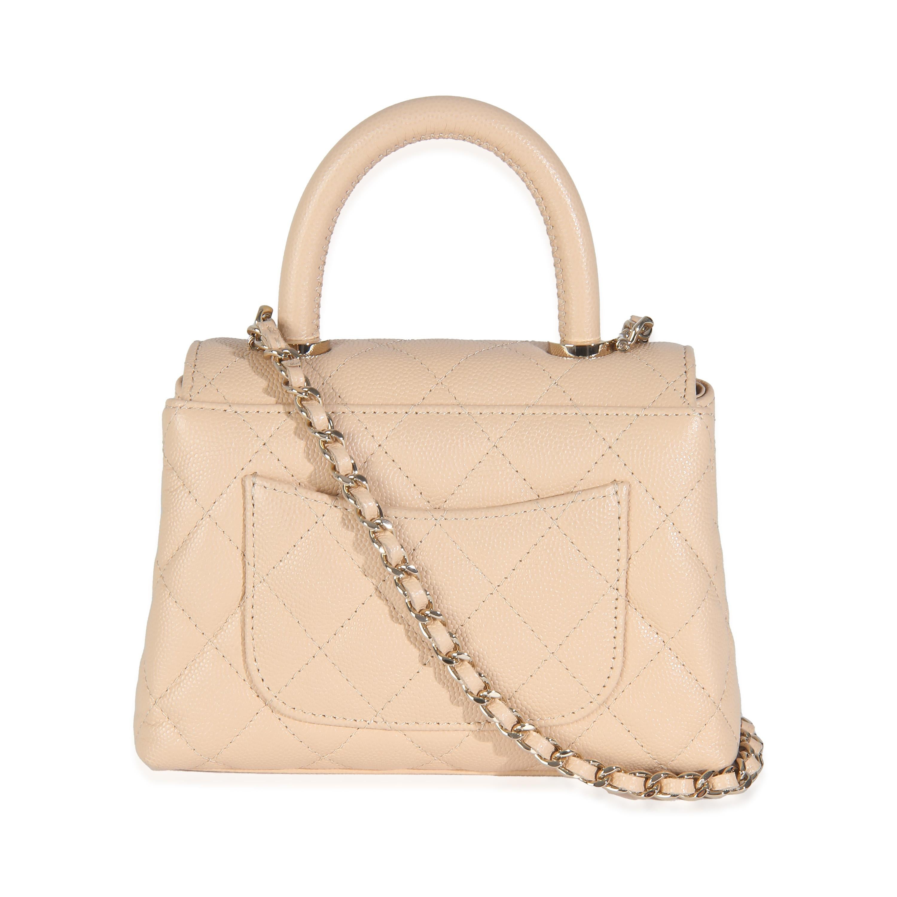 Listing Title: Chanel Beige Quilted Caviar Extra Mini Coco Top Handle Bag
SKU: Z146189
MSRP: 5600.00 USD
Condition: Pre-owned 
Condition Description: Intrinsically Chanel, the medium Coco top handle bag was named after the maison's founder.