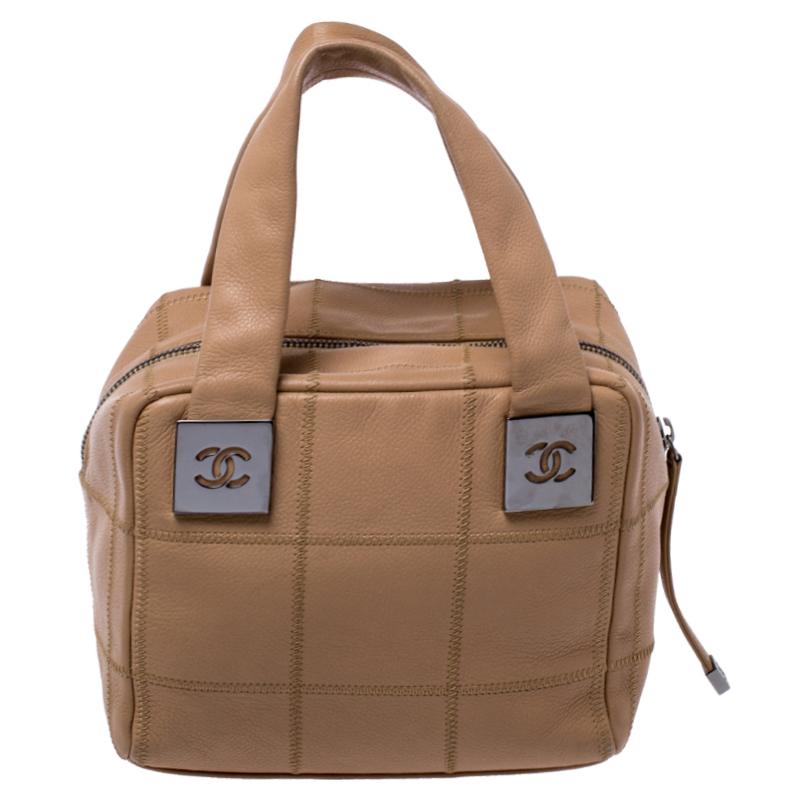 Radiate with elegance when you swing this Bowler bag from Chanel. Beautifully crafted from square quilted leather in beige, this bag is a beauty. Held by two handles, it comes with a spacious interior. This creation will surely be a great addition