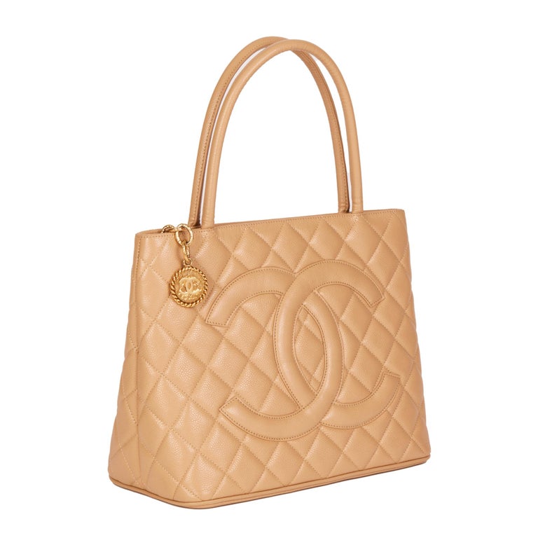 CHANEL
Beige Quilted Caviar Leather Vintage Medallion Tote

Xupes Reference: HB4410
Serial Number: 8313144
Age (Circa): 2003
Accompanied By: Chanel Dust Bag, Authenticity Card
Authenticity Details: Authenticity Card, Serial Sticker (Made in Italy)