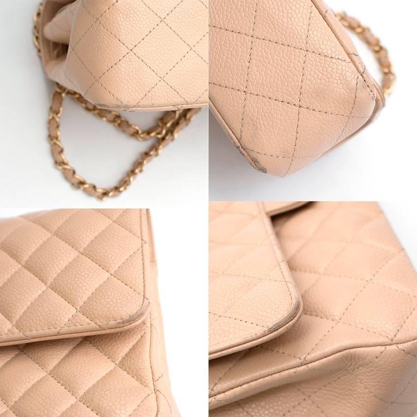 Chanel beige quilted leather double flap bag with gold hardware. 

Made in France. Double flap bag. Divided into three compartments. 

Features three interior zipped pockets, an exterior pouch, chain strap and signature Chanel CC logo.  

Fabric: