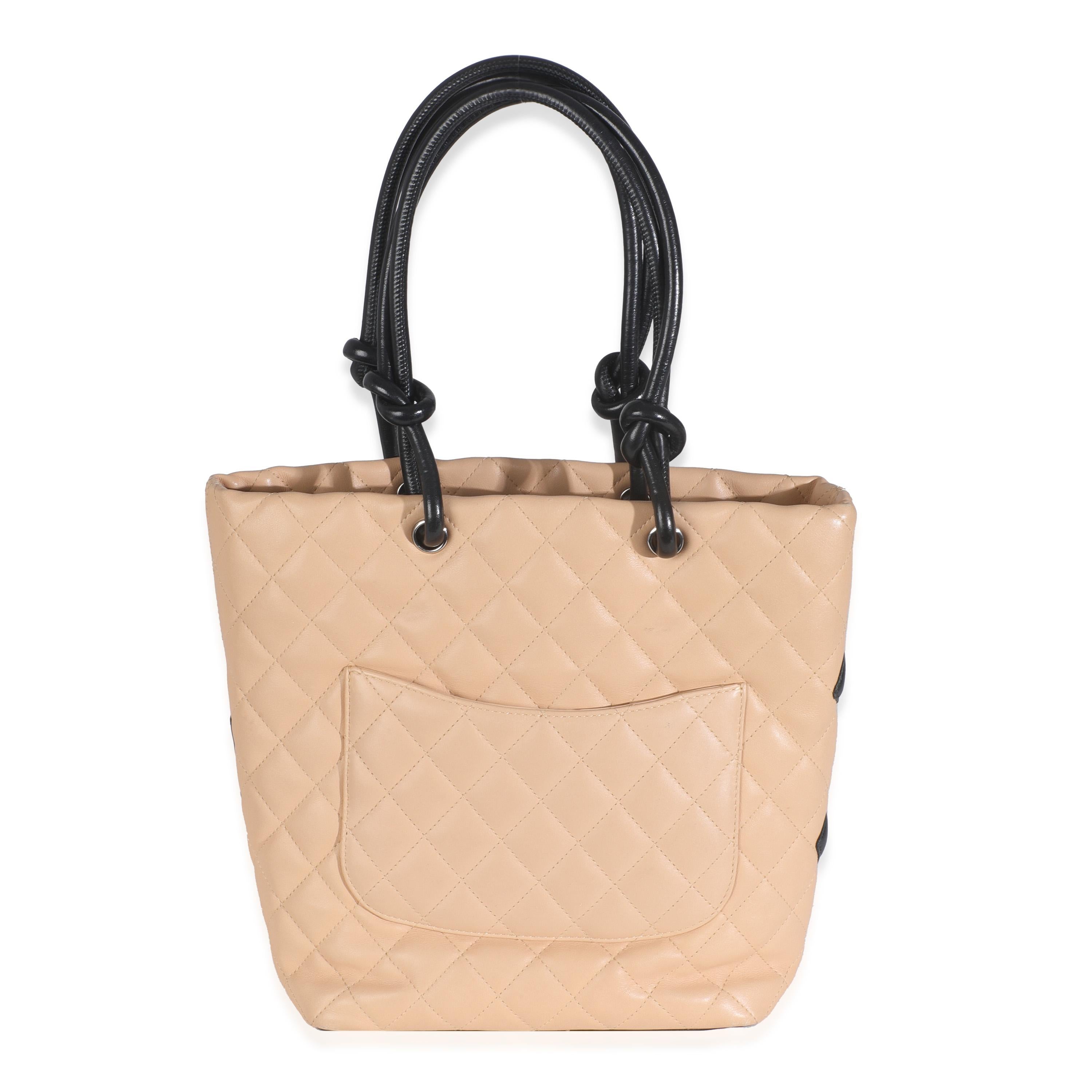 Listing Title: Chanel Beige Quilted Lambskin Cambon Bucket Bag
SKU: T146429
Condition: Pre-owned 
Handbag Condition: Very Good
Condition Comments: Item is in very good condition with minor signs of wear.   Scuffing, scratches and marks along