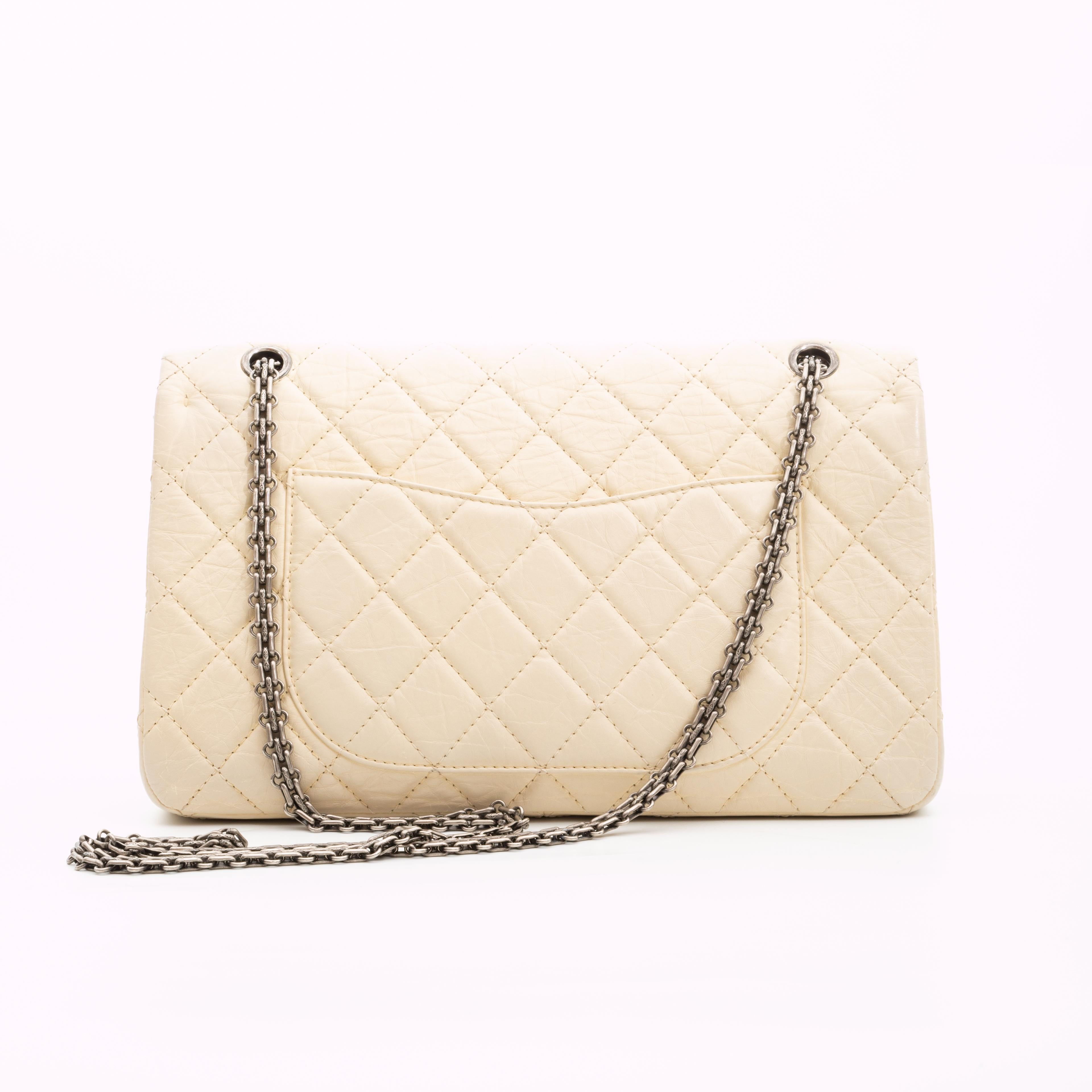 This shoulder bag is made of diamond quilted distressed calfskin leather in beige. The bag features an aged silver tone chain shoulder strap, a matching Mademoiselle turn lock, double flap interior and a matching beige leather interior with slip