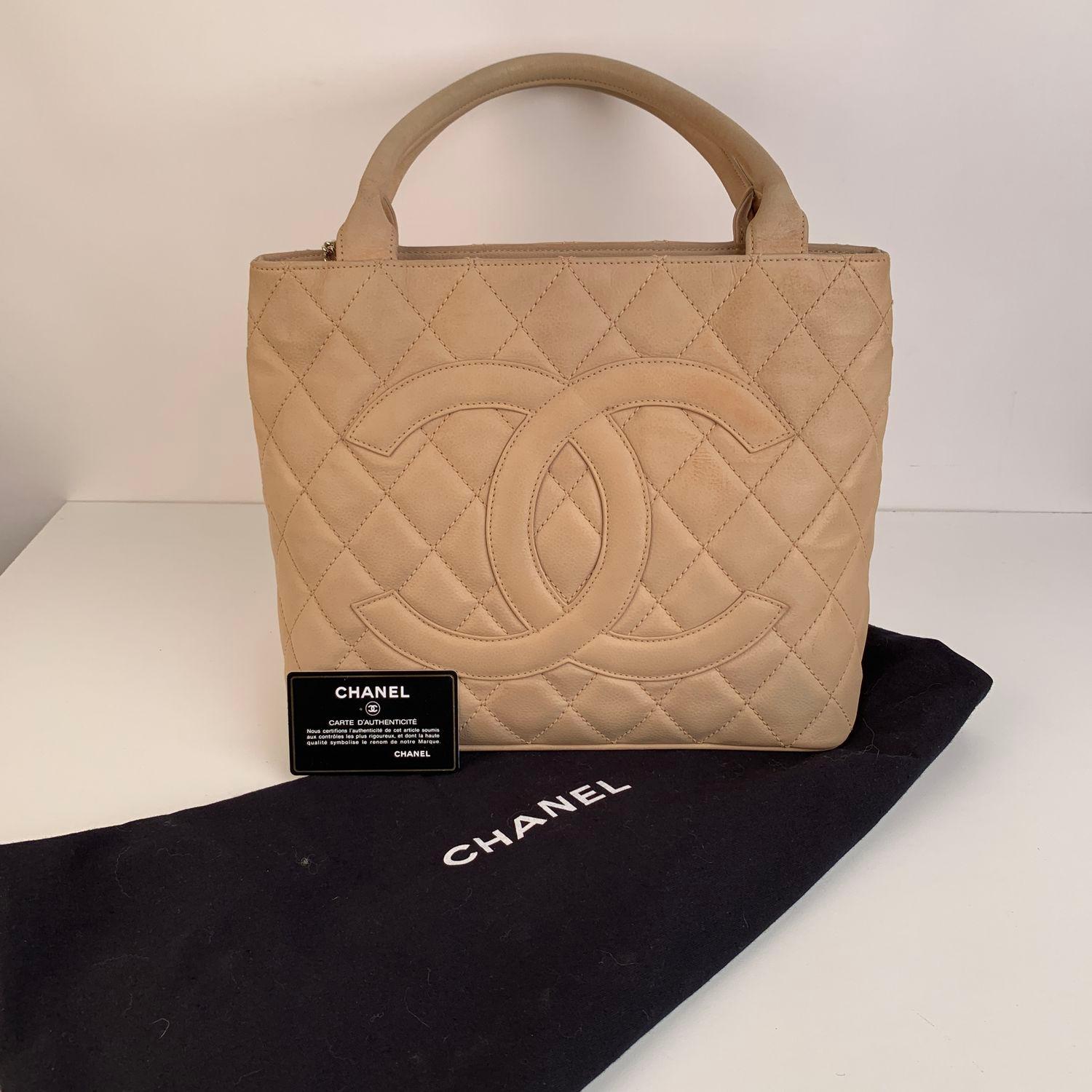 This bag will come with a Certificate of Authenticity provided by Entrupy, at no further cost.

Sophisticated beige quilted leather tote bag by CHANEL with big CC Chanel logo on the front. Rear patch pocket, Double rolled leather top handles. Upper