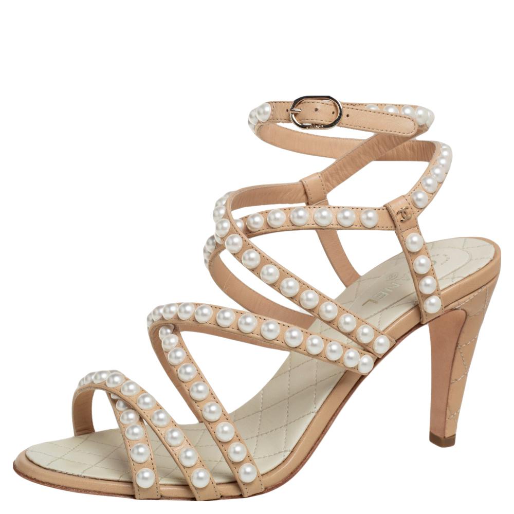 Chanel understands your need for comfort and style in these sandals. These beautiful leather sandals are a perfect option while choosing footwear for any occasion. They ring pearl-embellished straps, open toes, and 9 cm heels.

Includes: Original