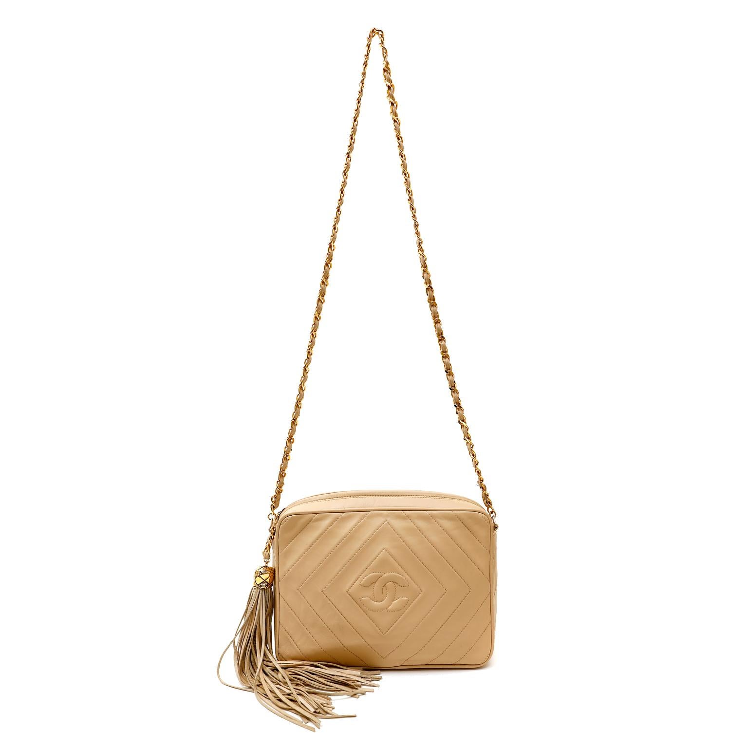 This authentic Chanel Beige Quilted Leather Camera Bag is in very good vintage condition. The classic silhouette has all the quintessential Chanel design elements that make it a true collectible.
Neutral beige leather is stitched with radiating