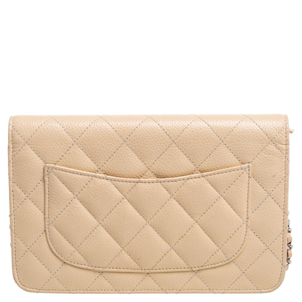 This wallet on chain creation from the house of Chanel will be your most-loved fashion asset! Skilfully crafted in Italy, the wallet is made from quilted leather in a beige shade accented by a long leather woven silver chain and features the CC logo