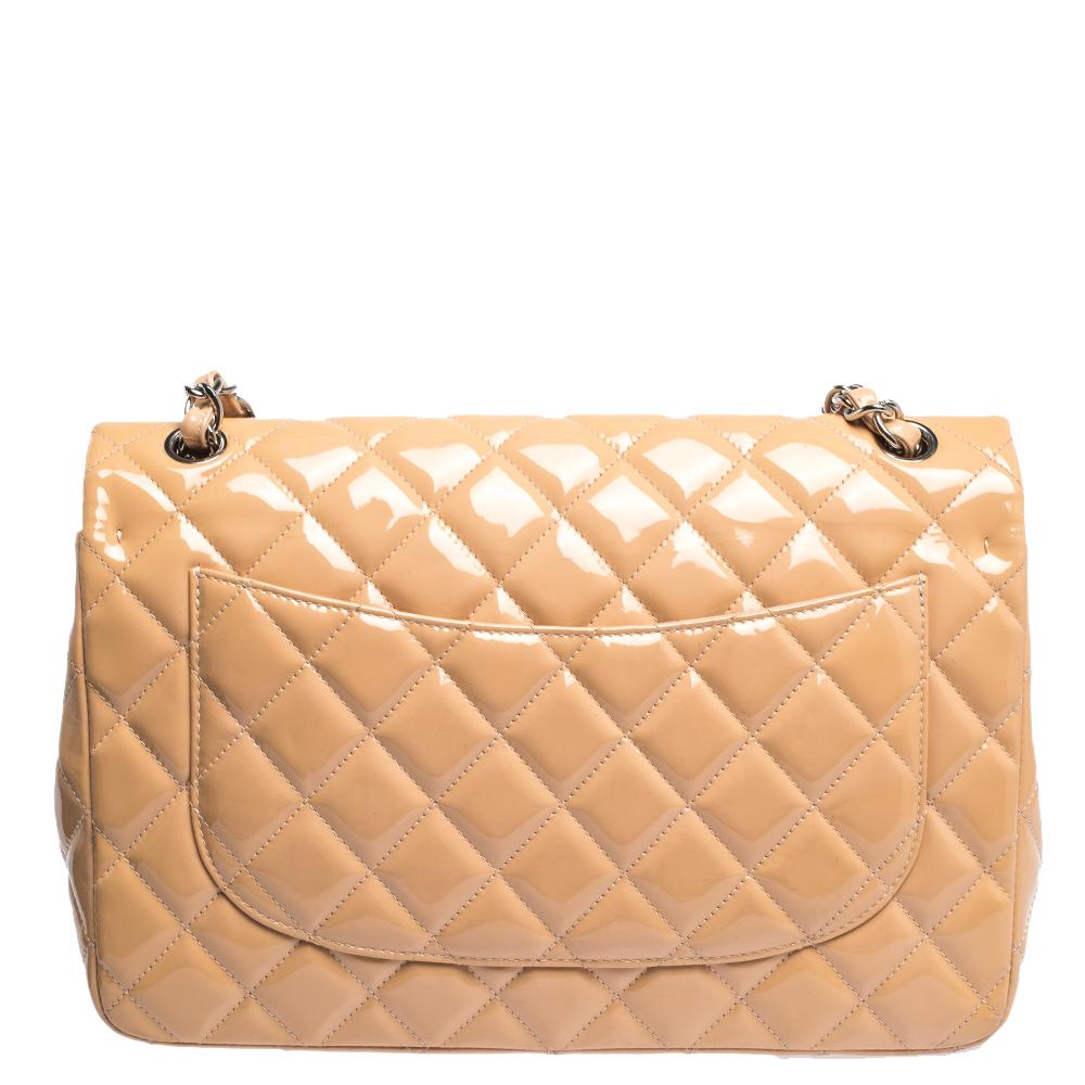 Wir sind von dieser Tasche mit doppeltem Überschlag von Chanel begeistert:: da sie auf eine surreale Art und Weise ansprechend ist. Sie ist aus Lackleder im Steppdesign gefertigt und trägt das charakteristische Etikett auf der Lederinnenseite sowie