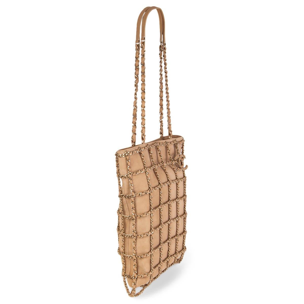 100% authentic Chanel Cruise 2020 large shopping chain tote in beige suede featuring light gold-tone metal chain and calfskin braided cage. Opens with a magnetic button on top and is lined in eggplant colored grosgrain fabric with a zipper pocket