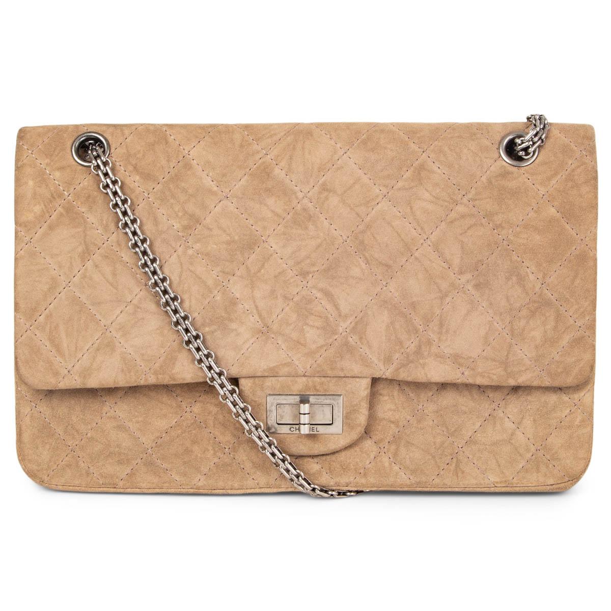 100% authentic Chanel 2.55 Reissue 227 Maxi  Double Flap Bag in distressd sand suese featuring antique silver-tone metal chain link shoulder-strap and turn-lock. Opens to a beige lined calfskin interior with one open pocket under the flap and one to