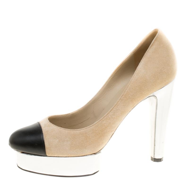 Take each step with style in these shoes from Chanel. Crafted from beige suede, they carry a modern design with black leather cap toes and platforms. The insoles are leather-lined to provide comfort and the pair stands tall on 12 cm