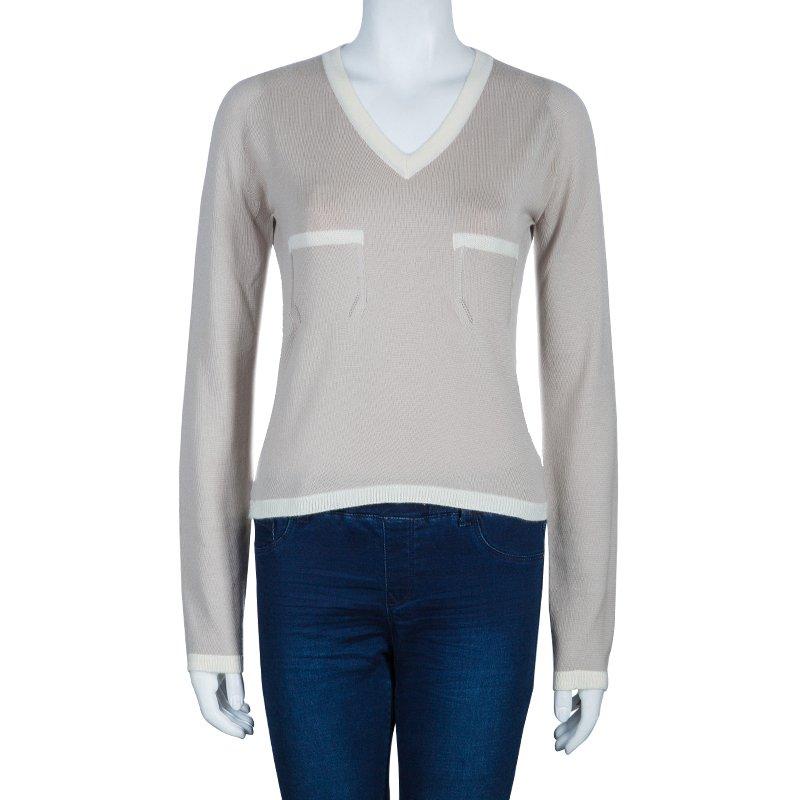 Pair this sweater with your denims. Knitted with rich cashmere, this sweater from the house of Chanel is accented with ribbed V-neck, hem, and cuffs in white color. It features long sleeves and two breast pockets.

Includes: The Luxury Closet