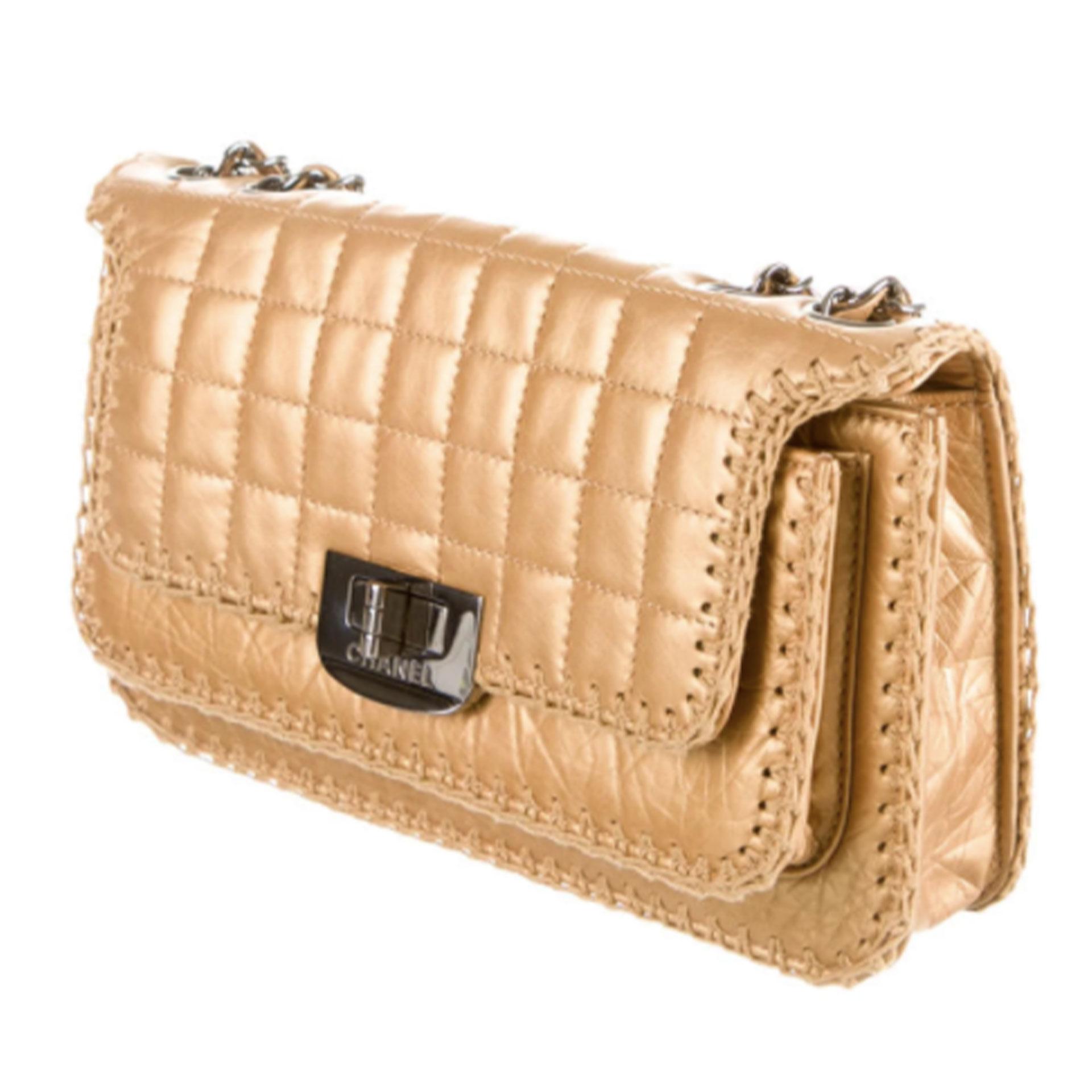 Chanel Whipstitch Flap Bag 

Metallic gold reissue quilted leather medium-small Chanel bag with gunmetal hardware, contrast fabric whipstitch trim throughout, dual leather and chain-link shoulder straps, single exterior pocket at front, metallic