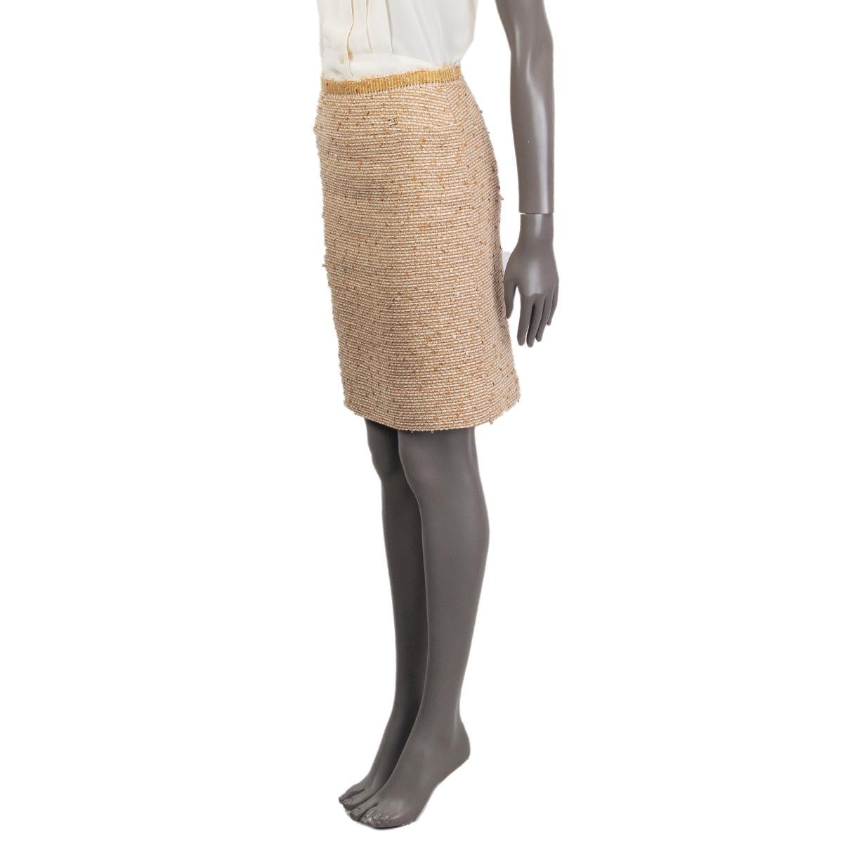 Chanel straight tweed skirt in beige, off-white and oatmeal wool (27%), linen (22%), polyester (21%), silk (12%),nylon (8%), acrylic (7%) and cotton (3%) with sequins. Opens with a zipper in the back. Lined in silk (100%). Has been worn and is in