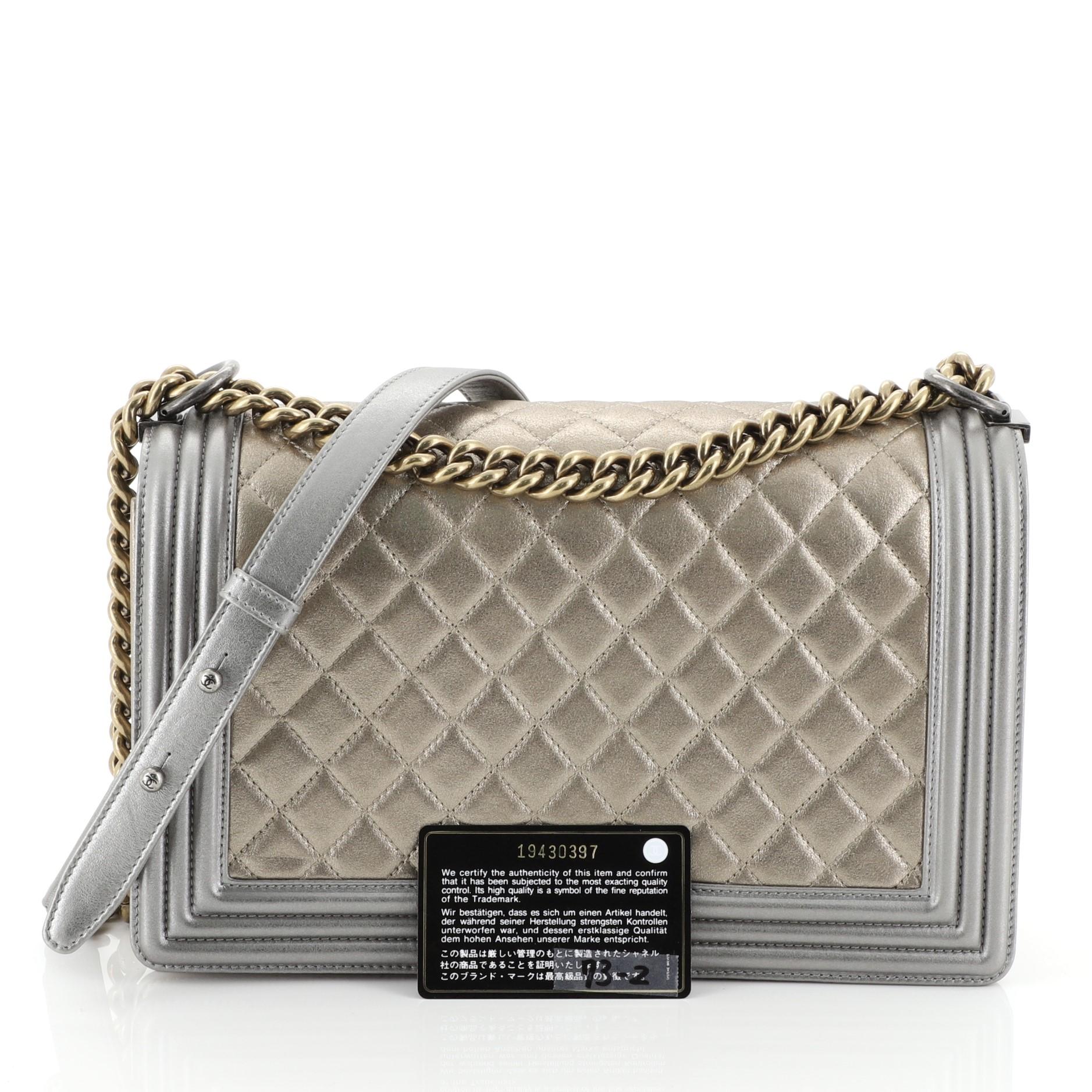 This Chanel Bicolor Boy Flap Bag Quilted Metallic Calfskin New Medium, crafted in gray and neutral quilted metallic calfskin leather, features chain link strap with leather pad and gold-tone hardware. Its CC logo boy push-lock closure opens to a