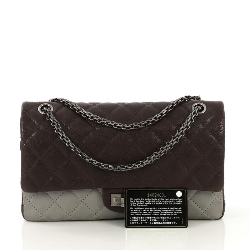 This Chanel Bicolor Reissue 2.55 Flap Bag Quilted Caviar and Washed Lambskin 227, crafted from brown quilted caviar and gray washed lambskin leather, features reissue chain link strap and aged silver-tone hardware. Its mademoiselle turn-lock closure