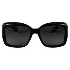 CHANEL 'Bijou' sunglasses comes in a black acetate featuring a metal crafted gol