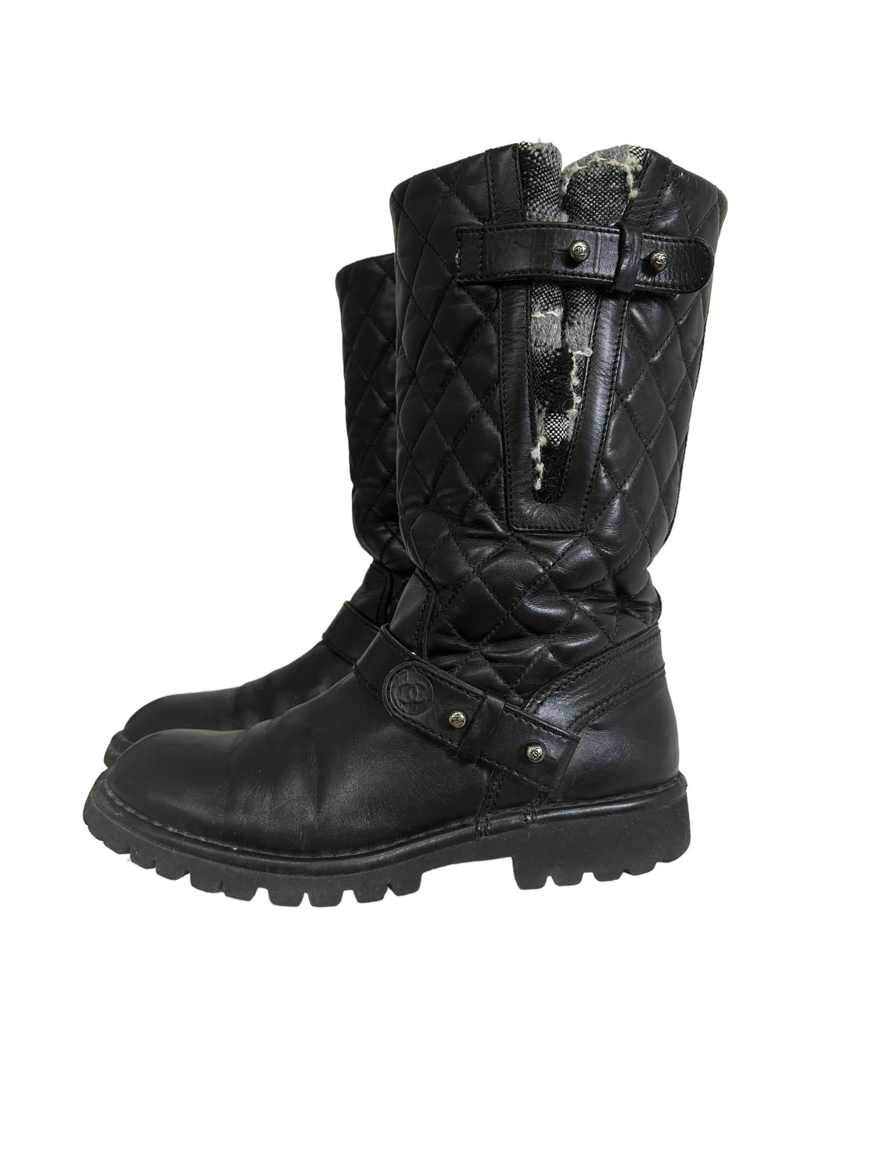 Boot signed Chanel, biker model, made in quilted black leather with silver hardware. They have no opening whatsoever. Featuring a double buckle and gray tweed inserts. Italian number 38 and 1\2, they are in good condition, with light signs of wear
