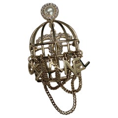 Chanel Birdcage brooch in Metal with Faux Pearl and Strass Detail from 2024