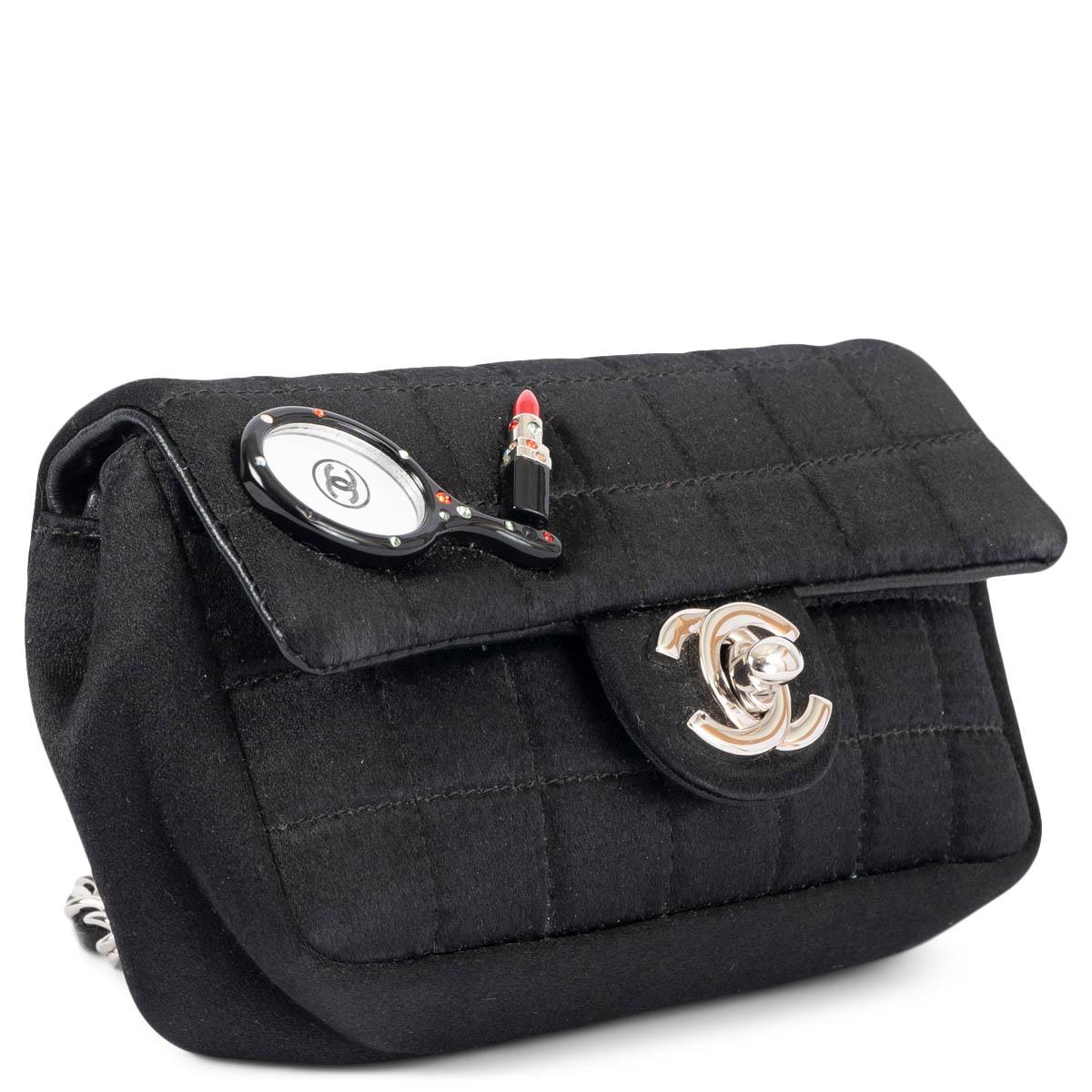 100% authentic Chanel 2004 Mirror & Lipstick shoulder bag in black quilted satin. The design features the classic silver-tone CC turn lock, chain shoulder-strap and is lined in a tonal jacquard logo satin. Has been carried and is in excellent