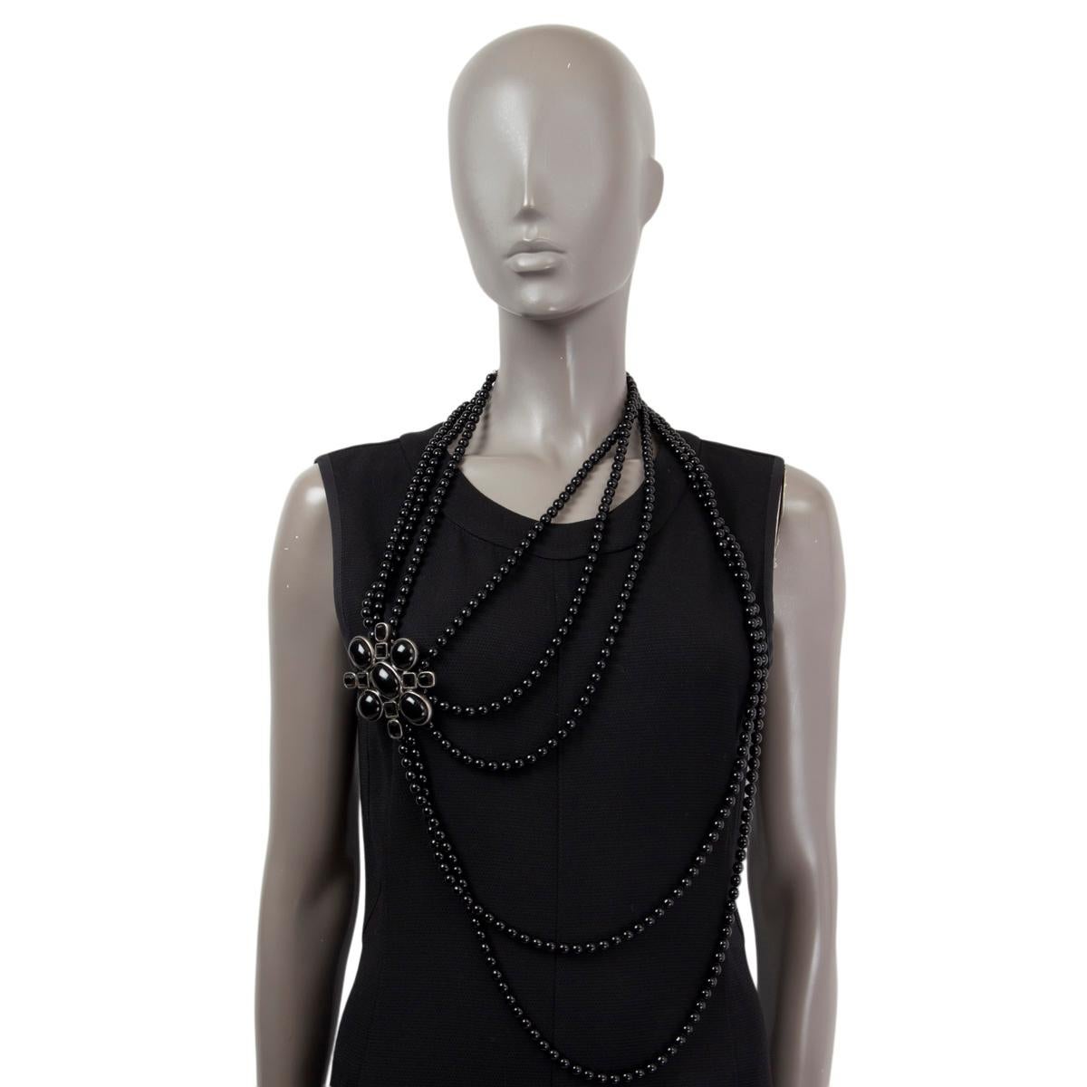100% authentic Chanel 2005 long faux pearl and beaded necklace in black with brooch pendant made of black stones. Can be worn as a necklace or belt. Has been worn and is in excellent condition. 

Measurements
Model	Chanel05P
Width	7cm