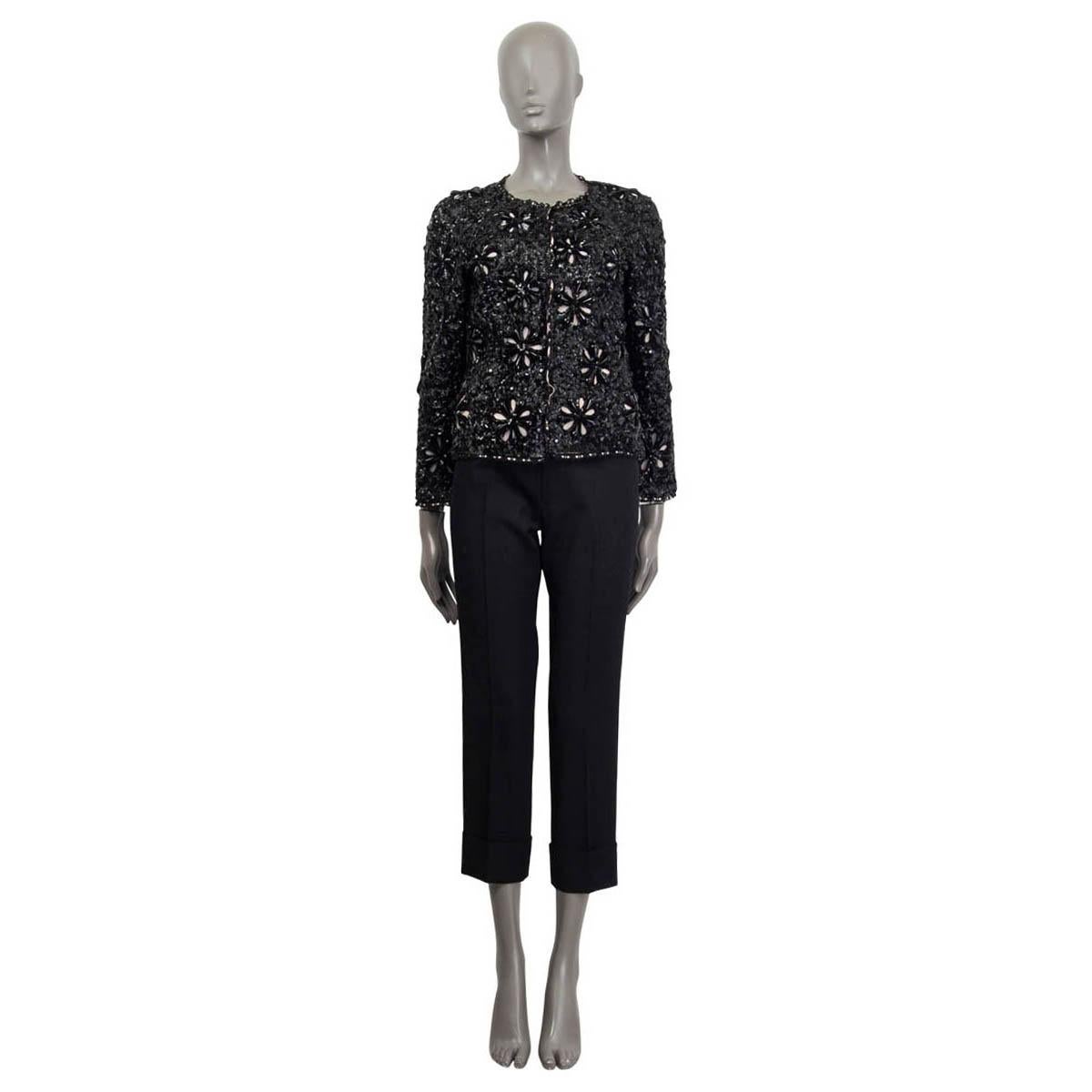 100% authentic Chanel 2010 sequins and beaded flower embellished jacket in black polyamide (100%) and nude silk (100%) lining featuring silver-tone metal chain along the hemline. Closes with 5 hidden hooks and has a black CC logo and Camellia