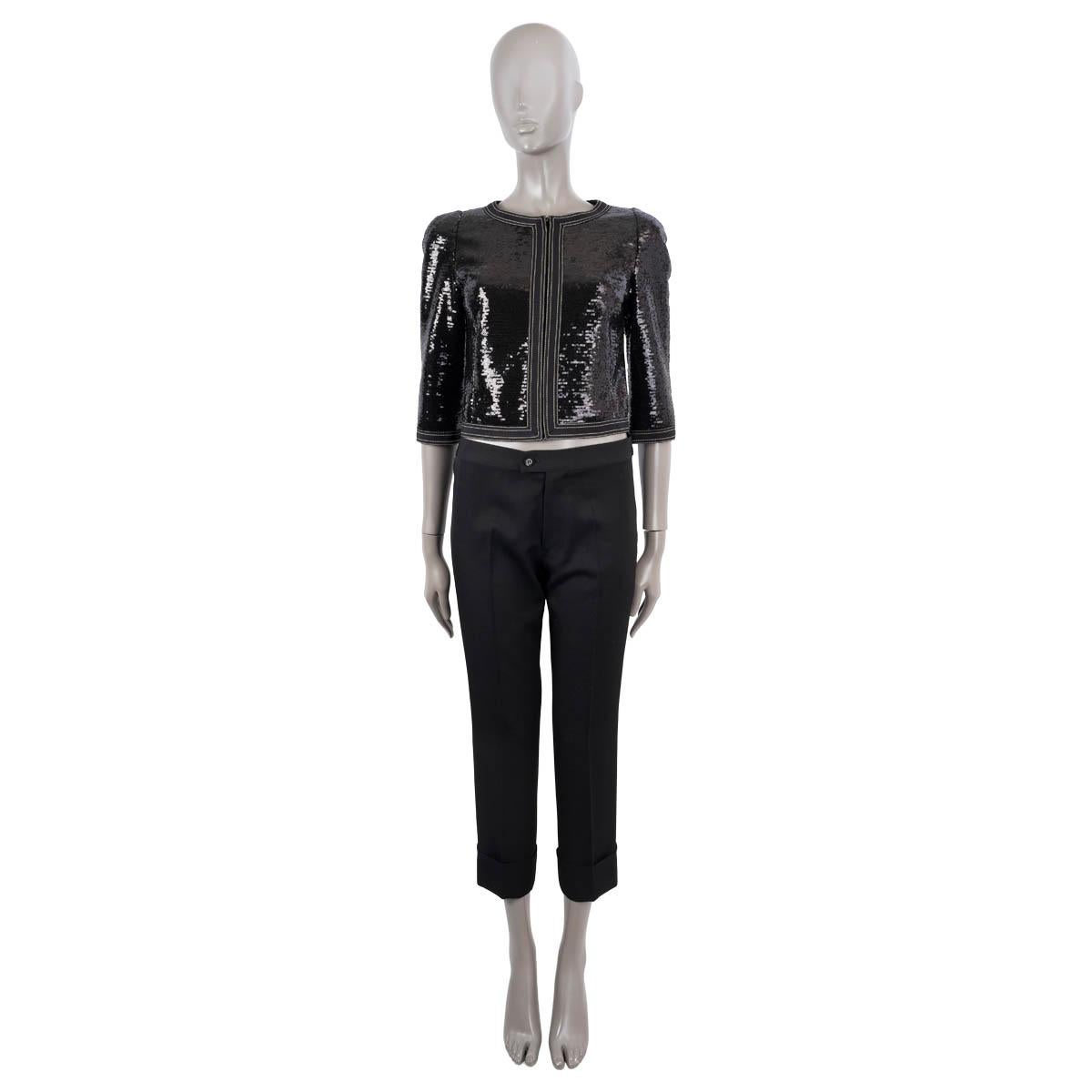 100% authentic Chanel collarless sequin jacket in black and white polyester (100%). Features white stitching along the seams and 3/4 sleeves. Closes with a black zipper on the front. Lined in black silk (100%). Has been worn and is in excellent