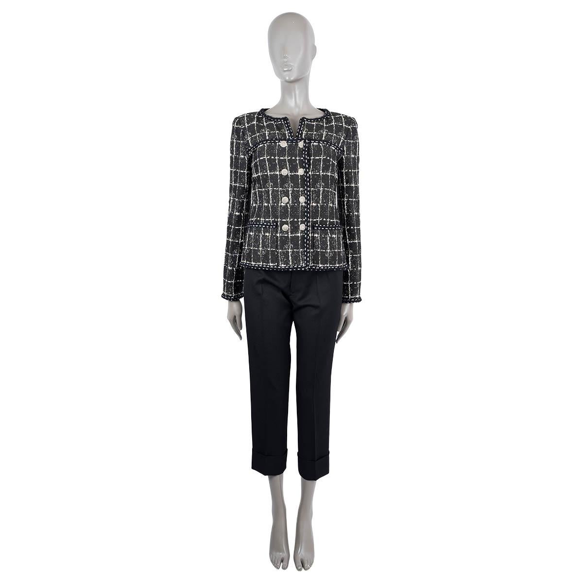 100% authentic Chanel collarless double-breasted tweed jacket in black polyamide (34%), silk (20%), polyurethane (18%), polyester (15%) and cotton (13%). Features woven metal and CC buttons, two front pockets and braided trims. Lined in silk (100%).