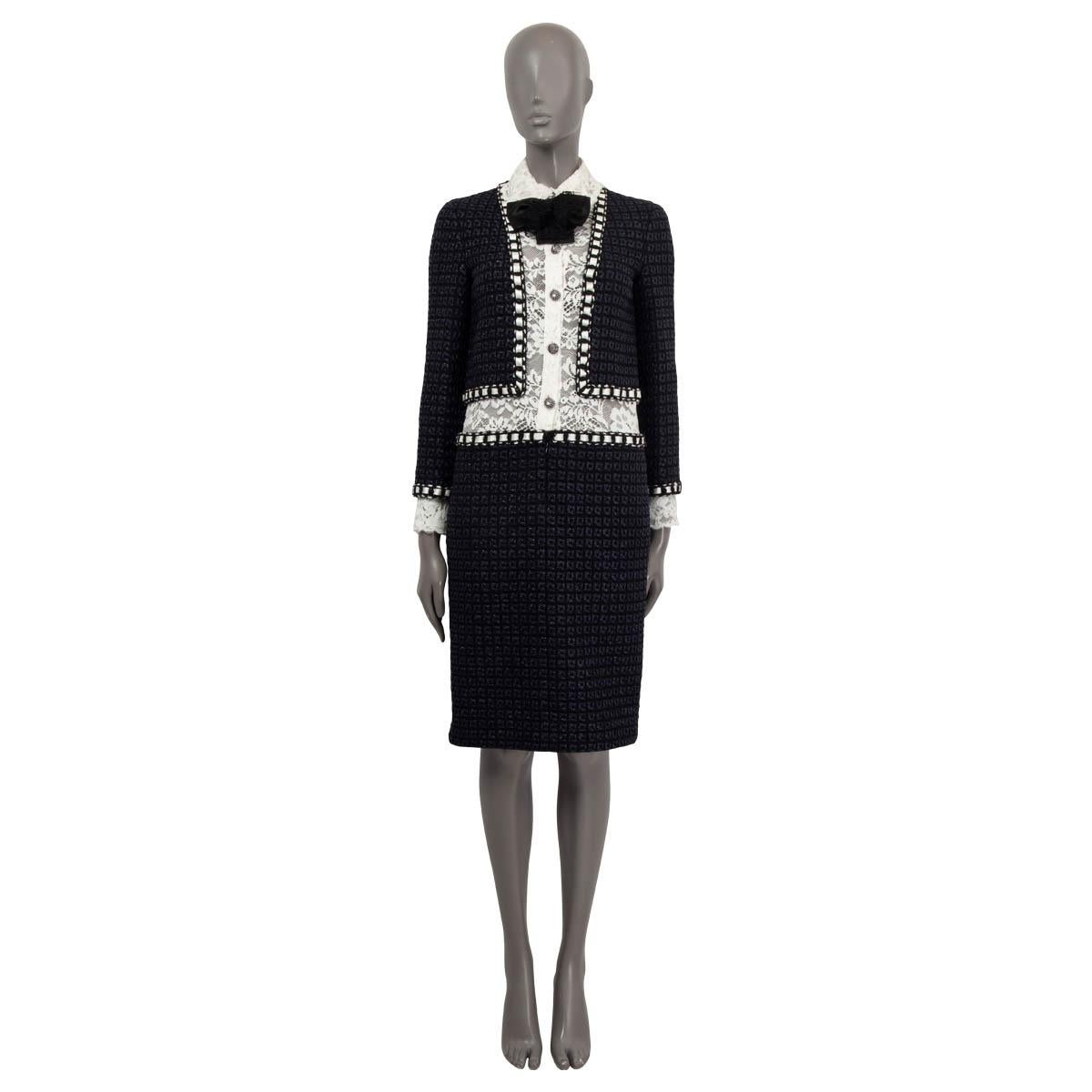 100% authentic Chanel Paris-Rome 2016 Metiers d'Art long sleeve boucle dress in navy, black and white wool (70%) and nylon (30%). Features lace details, a white satin trim and two sewn shut side slit pockets. Comes with buttoned, detachable lace