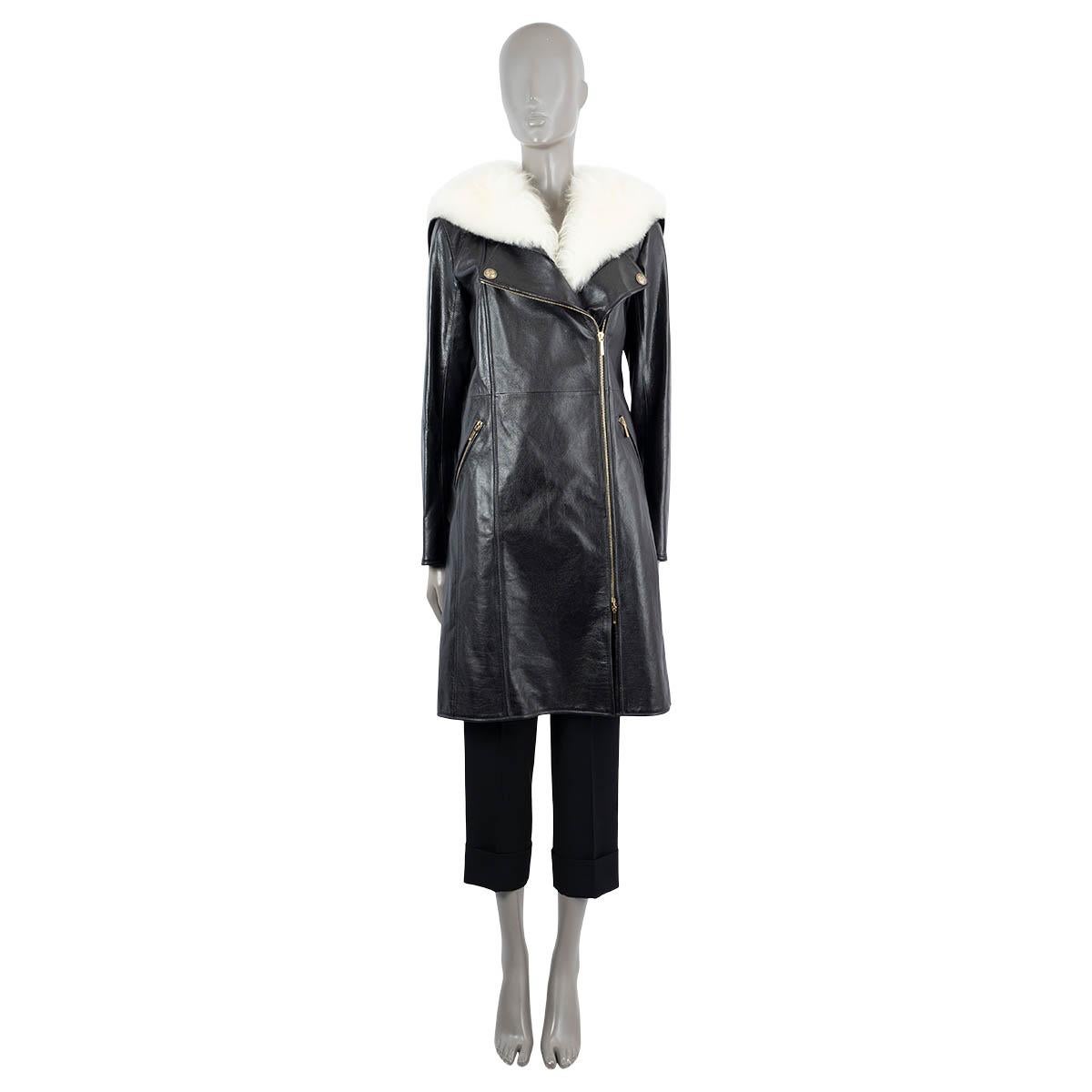 100% authentic Chanel coat in black calfskin leather (100%) with gold-tone hardware. Features a off-white shearling collar with back flap, zip detail on the sleeves with shearling trim and two zip pockets on the front. Closes with a zipper on the