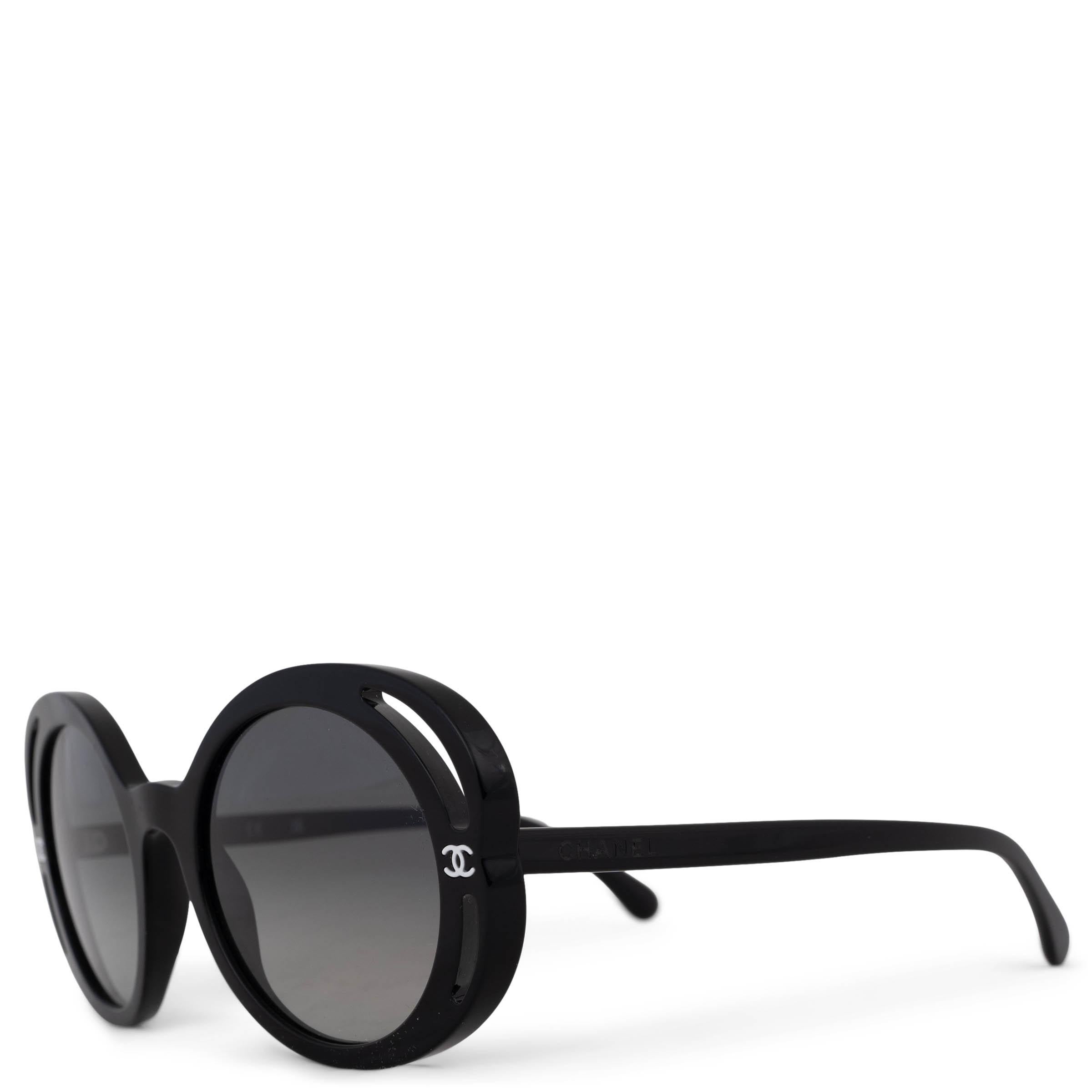 This 100% authentic Chanel Bold Camellia sunglasses in black acetate exude timeless elegance. Designed with round frames and gradient grey lenses, they feature a striking white CC on the front and signature engraving at the temples, adding a refined