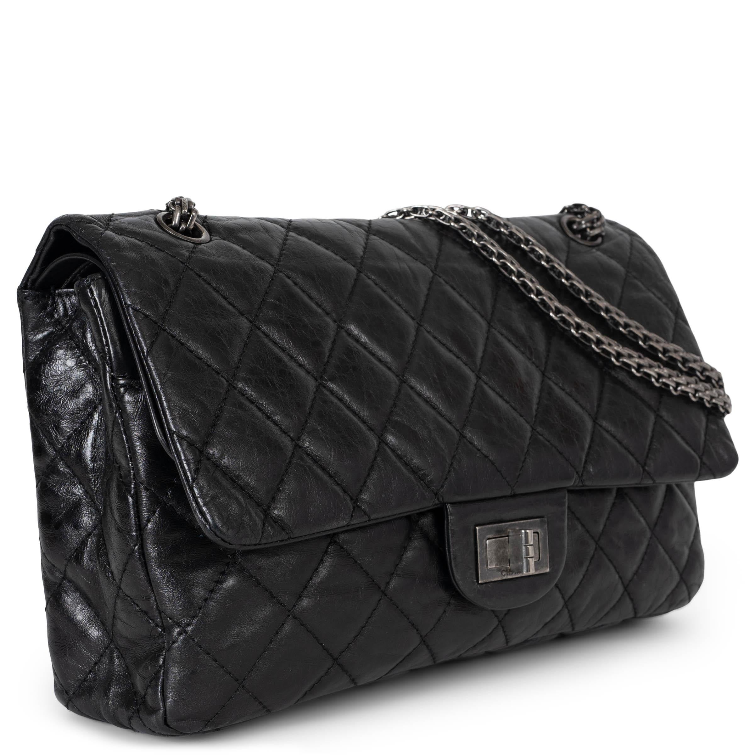 This 100% authentic Chanel 2.55 Reissue 227 double flap bag in black aged calfskin showcases the timeless elegance of the brand. Featuring classic diamond quilted stitching, it exudes sophistication and iconic appeal. The bag opens with a signature