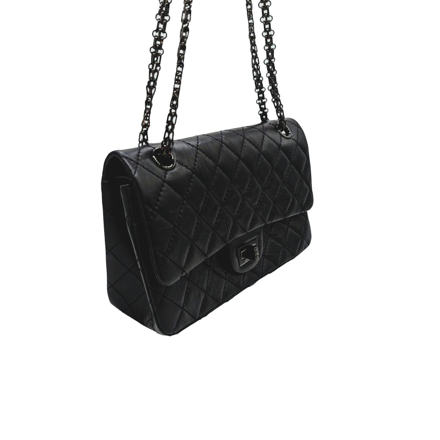 This stylish shoulder bag is beautifully crafted of diamond quilted aged black calfskin leather. The bag features black chain shoulder straps with a frontal black Mademoiselle turn-lock. This opens the front flap to an inner flap and a black matte